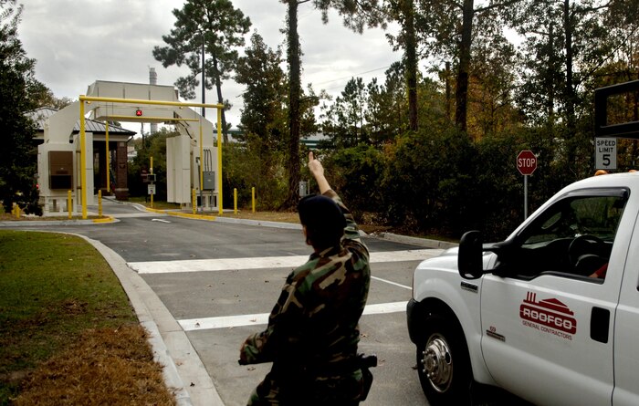 Senior Airman Danielle Avington, 437 SFS, gives the thumbs up for a contractor to drive through the new X-ray security system Monday at the Rivers Gate on Charleston AFB. (U.S. Air Force photo/Senior Airman Nicholas Pilch)