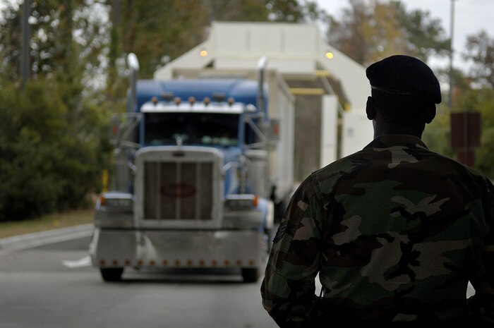 Staff Sgt Joseph Mattox, 437 SFS, supervises a truck as it drives through the new X-ray security system Monday at the Rivers Gate on Charleston AFB. (U.S. Air Force photo/Senior Airman Nicholas Pilch)