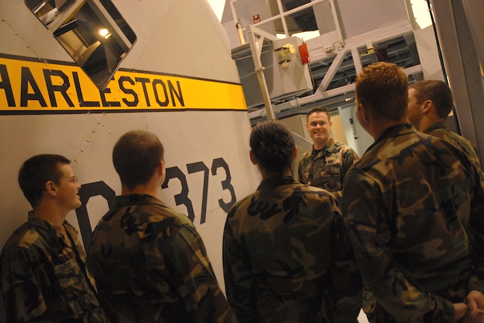Staff Sgt. Benjamin Howell, 373rd Training Squadron, Detachment 5 aero-repair instructor, discusses the upper and lower rudder operations on a C-17 with Air Force Specialty Code pipeline students using an aircraft system flight control training device on base Monday. (U.S. Air Force photo/Airman Melissa White)