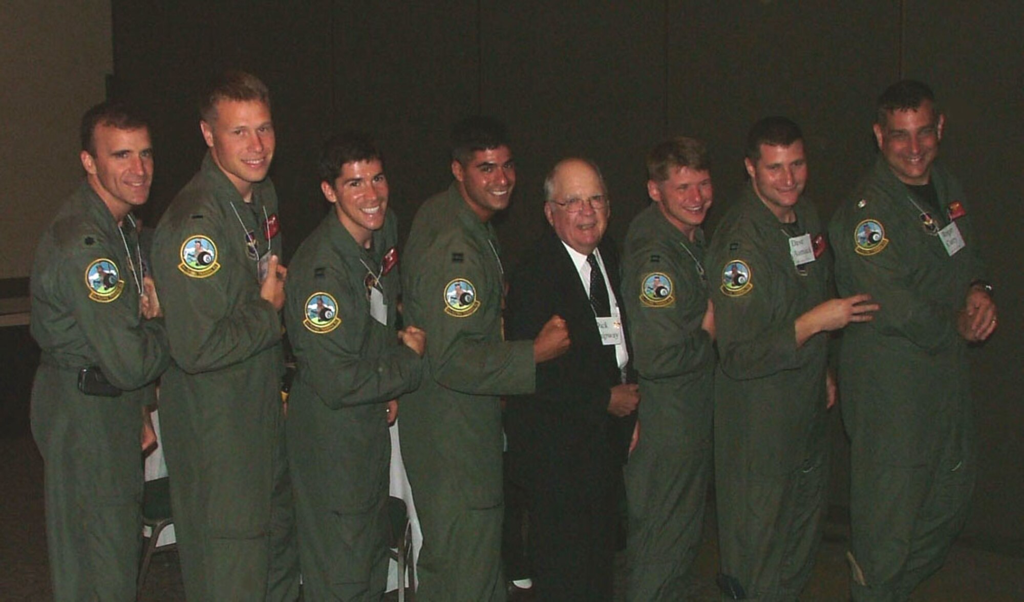 A team from the 8th Flying Training Squadron at Vance Air Force Base shows off the squadron's patch, originally designed by the 8th Photo Reconnaissance Squadron established in 1942 . From left to right, Lt. Col. Neil Woods, 1st Lt. Josh Dean, Capt. J.R. Gibbens, Capt. Ricky Amezaga, man in the suit, Capt. Spencer Rasmussen, Capt. Dave Aumack, Cmdr Roger Curry. (Courtesy photo)