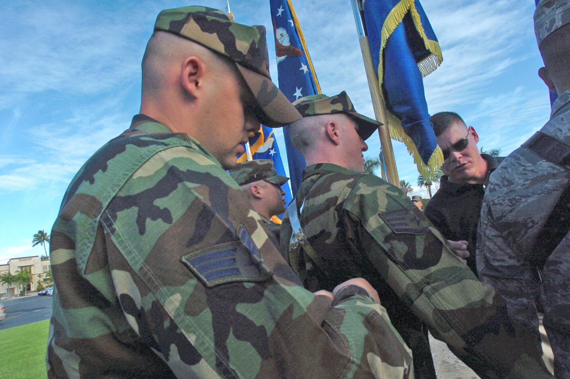 Senior Airman Tyler Wyatt a Misawa AB Honor Guard member adjusts the harness of a fellow honor guard member under the watchful eye of Staff Sgt. David Little, Air Force Honor Guard Program course supervisor from Bolling AFB, Washington D.C. The all Pacific Air Force’s Honor Guard team is preparing for the PACAF change of command ceremony scheduled for Friday at 4 p.m. at Hickam’s Atterbury Circle Park. (U.S. Air Force photo/Mark Munsey)

