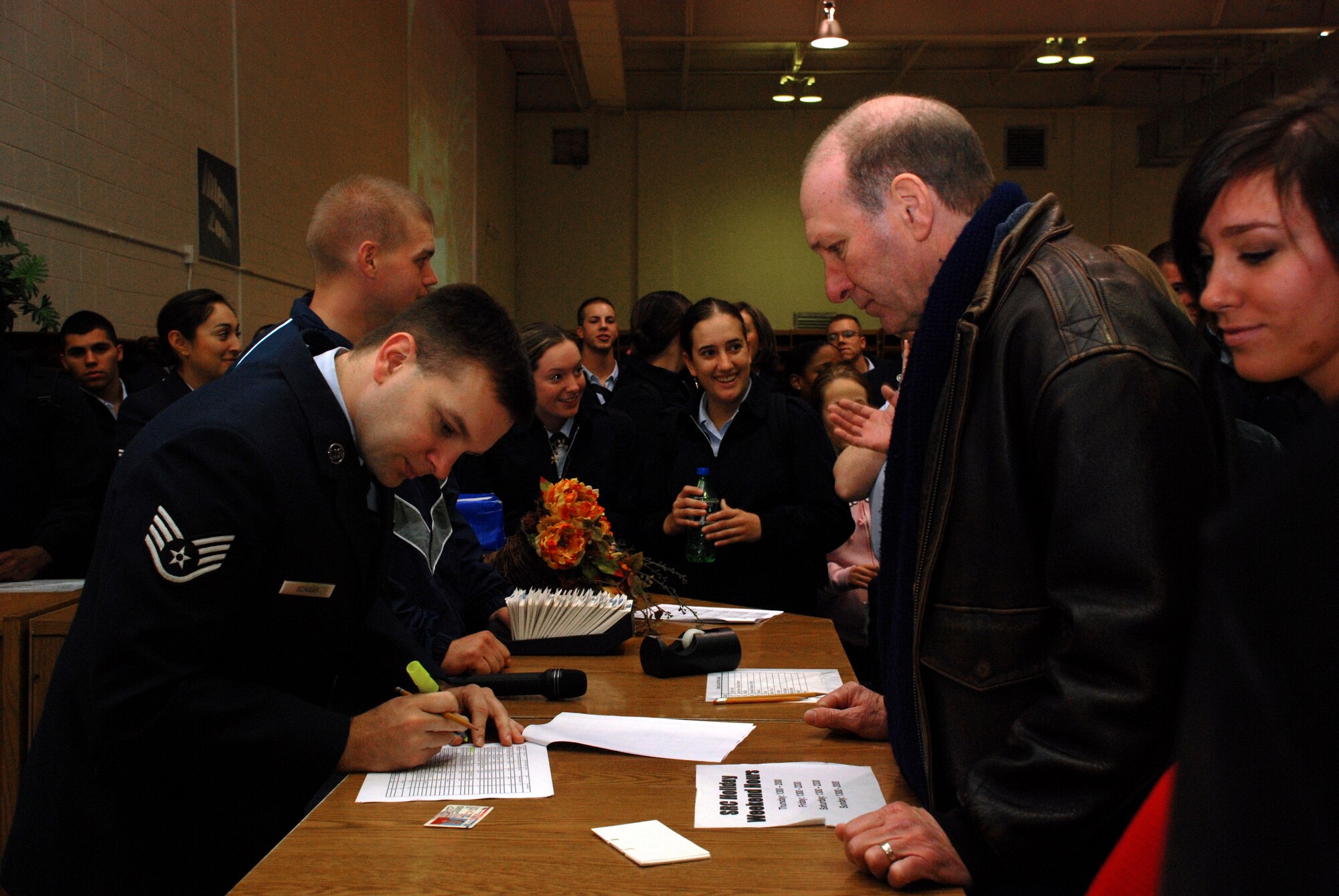 Staff Sgt. Brian Schaaf, NCO in charge of the Solid Rock Cafe, helps Rex Keese, a local resident of Wichita Falls, to sign up for Operation Thanksgiving Nov. 22 at the Solid Rock Cafe. (U.S. Air Force photo/Airman 1st Class Jacob Corbin)