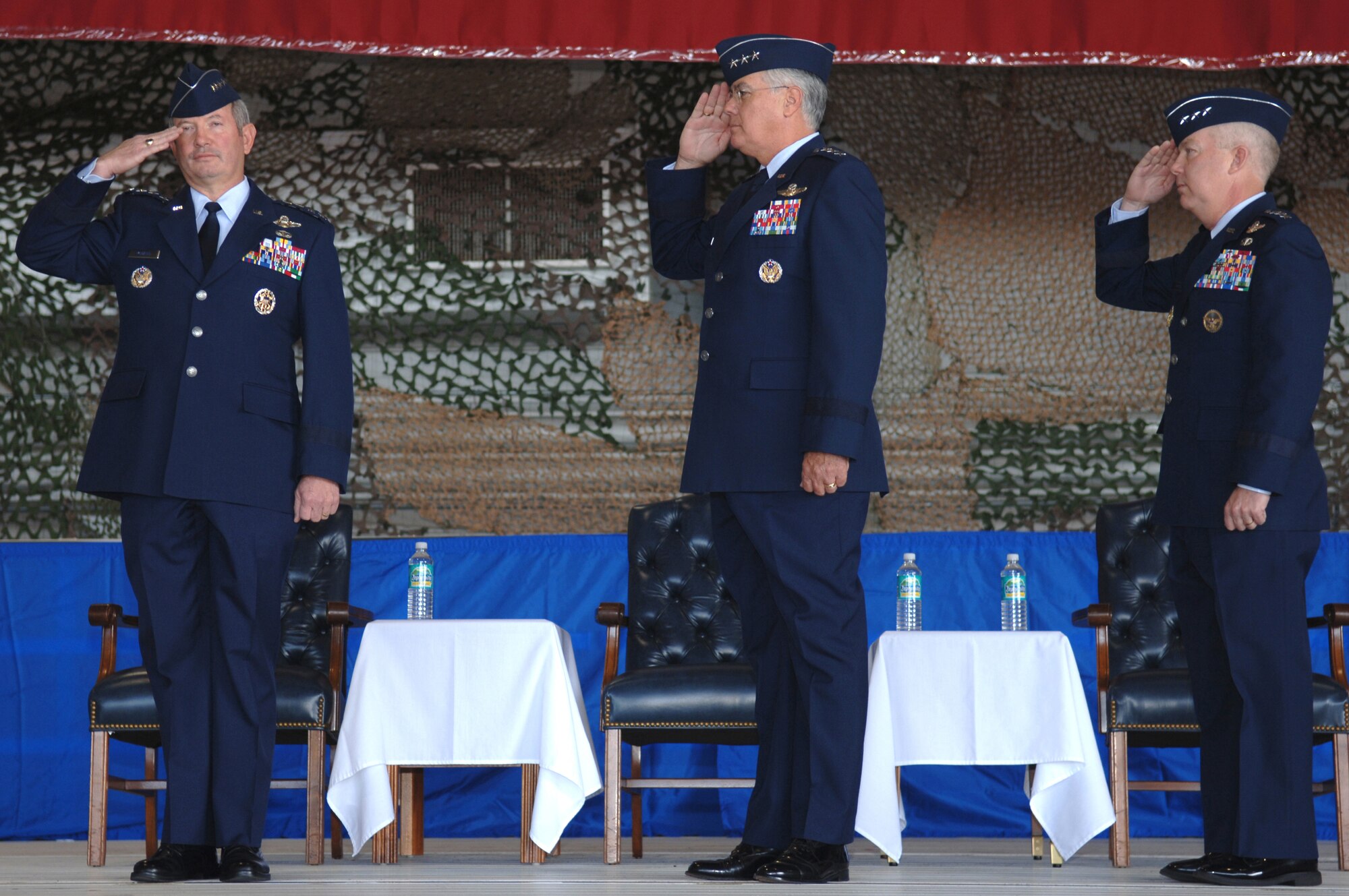 Air Force Vice Chief of Staff General Duncan McNabb, Lt. Gen. Mike Wooley and Lt. Gen. Donnie Wurster render salutes during the Air Force Special Operations Command change of command ceremony Nov. 27 at Hurlburt Field, Fla. (U.S. Air Force photo/Senior Airman Ali Flisek)