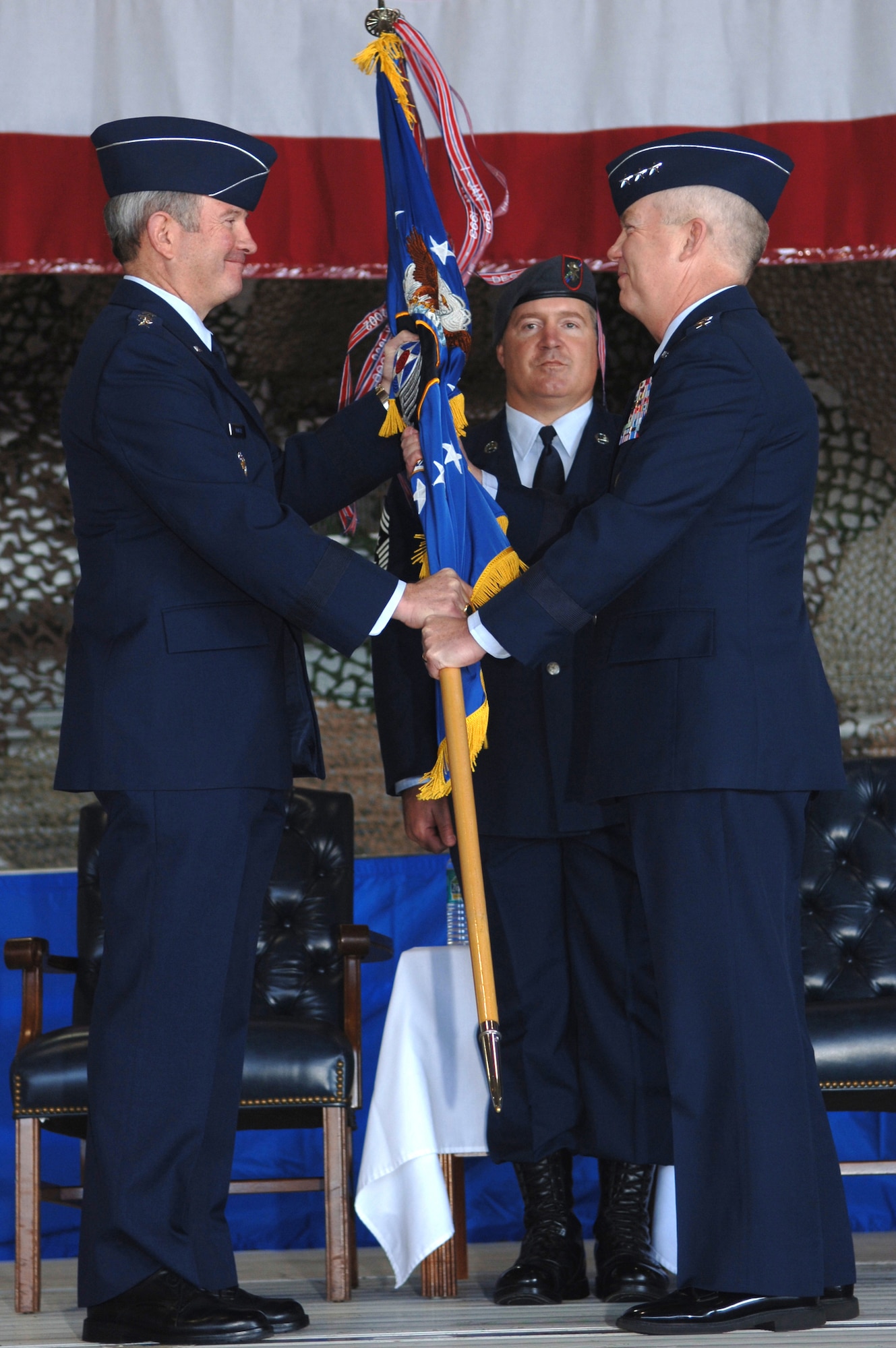 Lt. Gen. Donnie Wurster (right) accepts command of Air Force Special Operations Command from Air Force Vice Chief of Staff Gen. Duncan McNabb (left) as Chief Master Sgt. Michael Gilbert looks on during a change of command ceremony Nov. 27 at Hurlburt Field, Fla. (U.S. Air Force photo/Senior Airman Ali Flisek) 