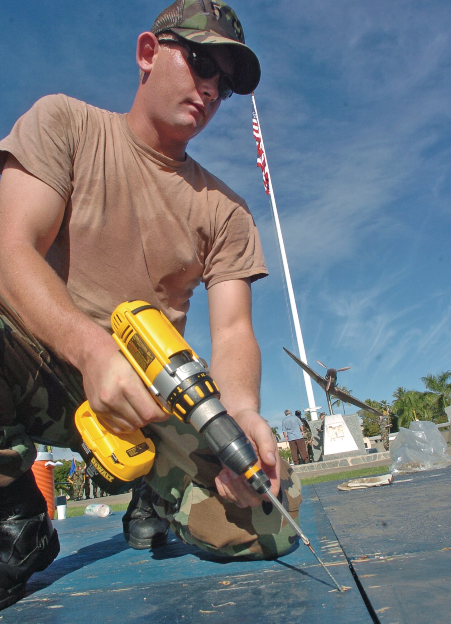 Airman 1st Class Nathan Jones, 15th Civil Engineer Squadron, secures a portion of the stage Tuesday at Atterbury CIrcle Park on Hickam AFB. The stage was constructed for the Pacific Air Force change of command scheduled for Friday 4 p.m. (U.S. Air Force photo/Mark Munsey)

