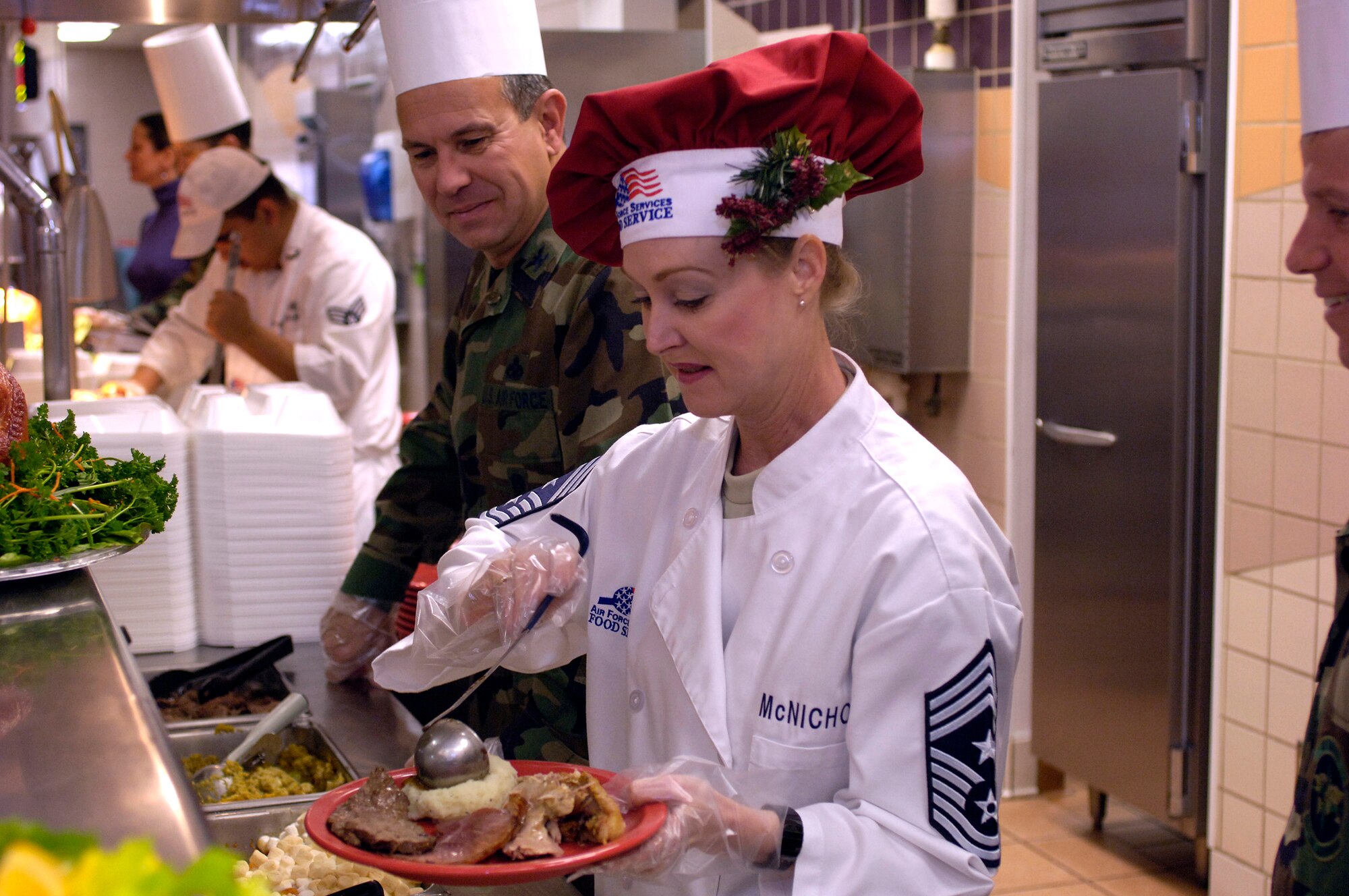 Chief Master Sgt. Marjorie McNichols, 49th Fighter Wing command chief, serves food at the Holloman AFB Thanksgiving day dinner. This annual feast is put on by the 49th Services Squadron for the Holloman populace. (U.S. Air Force photo/ Staff Sgt. Jason Colbert)