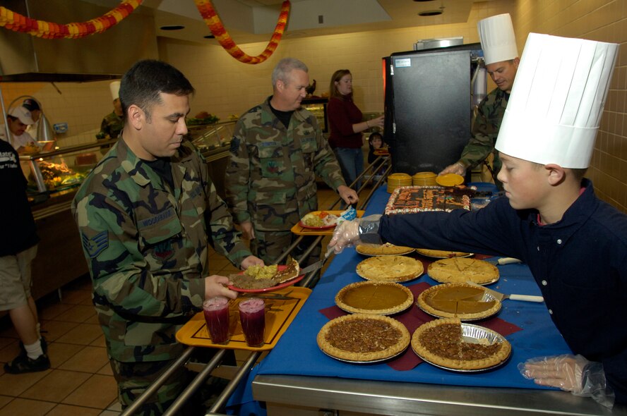 12-year-old Michael McGee III, son of Col. Michael McGee, 49th Fighter Wing vice commander, serves pie during the Thanksgiving Day Dinner at Holloman AFB. This annual feast is put on by the 49th Services Squadron for the Holloman populace. (U.S. Air Force photo/ Staff Sgt. Jason Colbert)