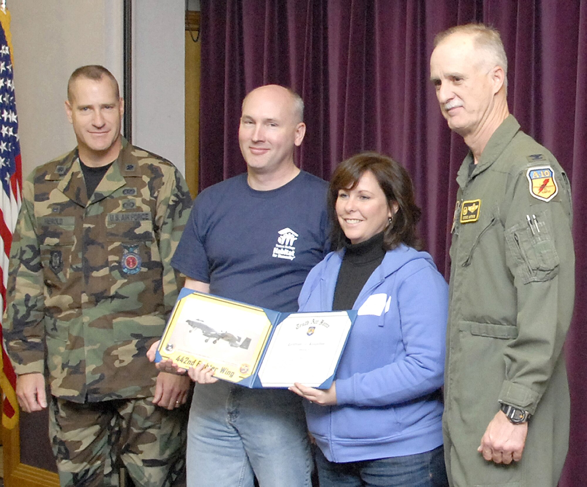 Lt. Col. Joseph Herold, 442nd Civil Engineer Squadron commander, joins his civilian employers, Steve Coker and  Kim Ganote, Sprint-Nextel, as they display a 10th Air Force Certificate of Recognition which had been presented to them by Col. Steve Arthur, 442nd Fighter Wing commander. Sprint-Nextel was recognized for their support of Colonel Herold and the Air Force Reserve. The presentation was made during the 442nd's annual Employer Appreciation Day Nov. 3. (US Air Force photo/TSgt. John Vertreese)