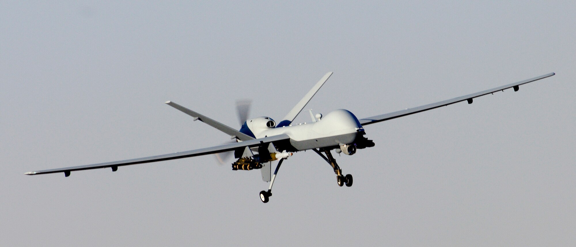 An MQ-9 Reaper unmanned aerial attack vehicle descends into an air field in Afghanistan Nov. 17 after a mission.  The Reaper is able to carry both precision-guided bombs and missiles.  (U.S. Air Force photo/Staff Sgt. Brian Ferguson)