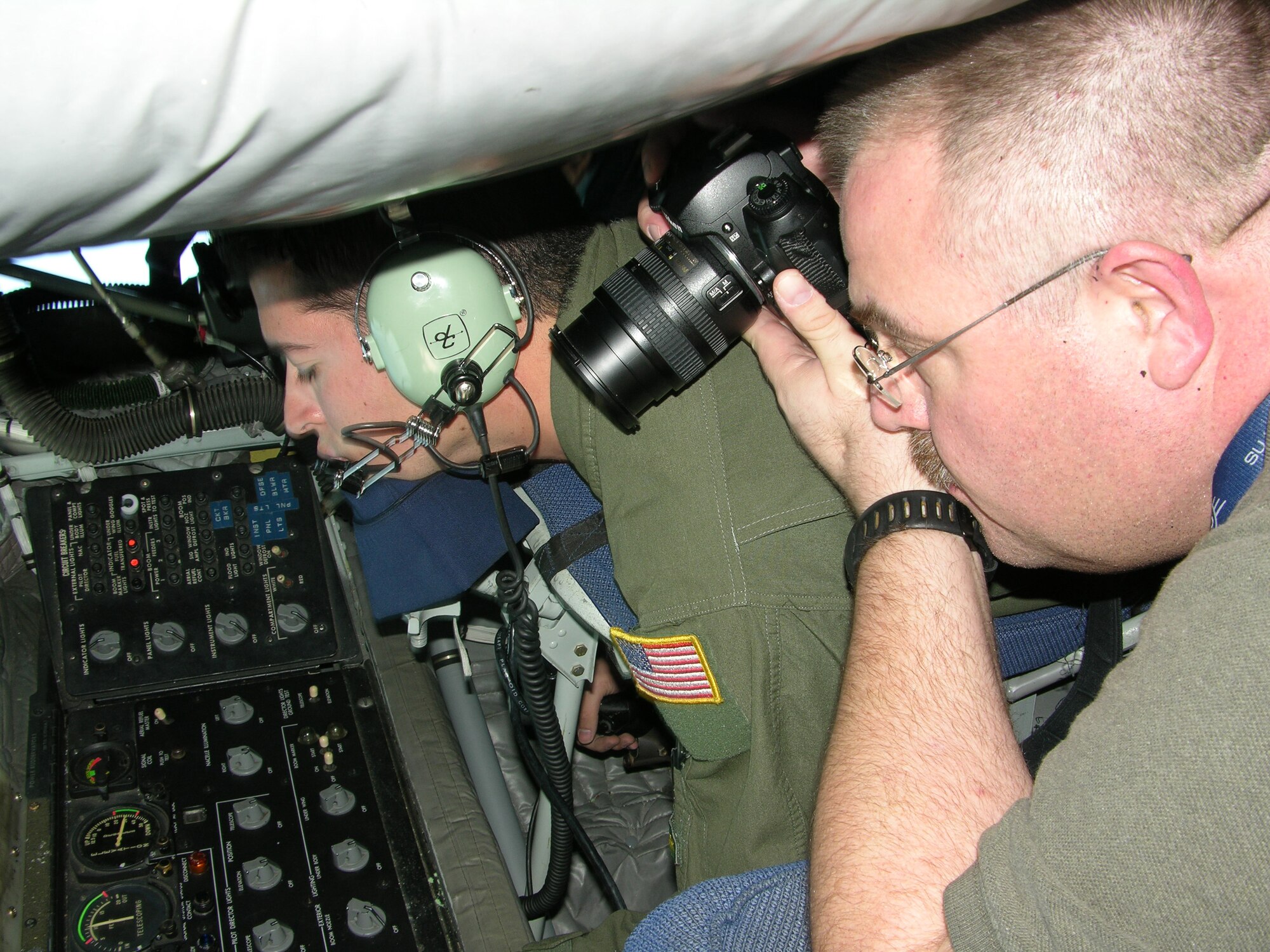 SEYMOUR JOHNSON AIR FORCE BASE, N.C.--Senior Airman Brice Hayden focuses on his job of refueling a fighter at 20,000 feet while freelance photographer Ralph Shepherd takes a picture of the action. The 916th Air Refueling Wing, Air Force Reserve, hosted a media orientation flight in mid-November in which local radio personalities joined with freelance photographers from as far away as California to learn about the Reserve mission and capture it on film and tape.