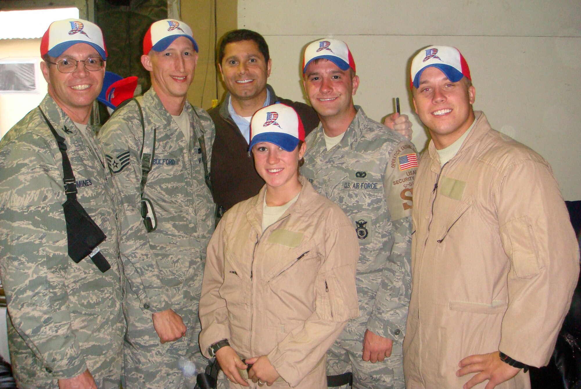 Air Force Chief of Staff, Gen. T. Michael Moseley recently invited civic leaders from across the country for a first-hand look at Air Force combat operations.  Here J.P. Nauseef, president of the Dayton Development Coalition, meets Wright-Patterson Airmen currently deployed to Bagram Air Base, Afghanistan.  Pictured sporting hats of the Dayton Dragons baseball team are (from left): Col. Barry Mines, Dean of Air Force Institute of Technology's Civil Engineer and Services School; Staff Sgt. Mychael Bulford, assistant NCOIC Student Services, AFIT Graduate School of Engineering and Management; Nauseef; and Airman 1st Class Valerie Johnson, Airman 1st Class Shawn Spithaler and Senior Airman Matthew Bollengier, all with the 88th Security Forces Squadron. (contributed photo)
