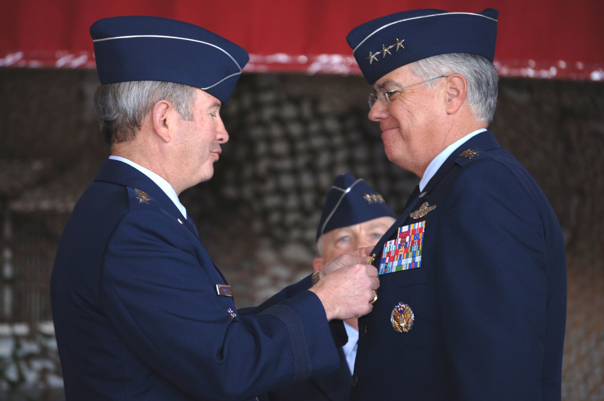 Gen. Duncan McNabb, Air Force vice chief of staff, presents the Distinguished Service Medal to Lt. Gen. Mike Wooley, former Air Force Special Operations Command commander, during the AFSOC change of command ceremony Nov. 27 at Hurlburt Field, Fla. General Wooley relinquished command to Lt. Gen. Donny Wurster during the ceremony and will retire Jan. 1 after a 35-year Air Force career. (U.S. Air Force photo/Senior Airman Ali Flisek)