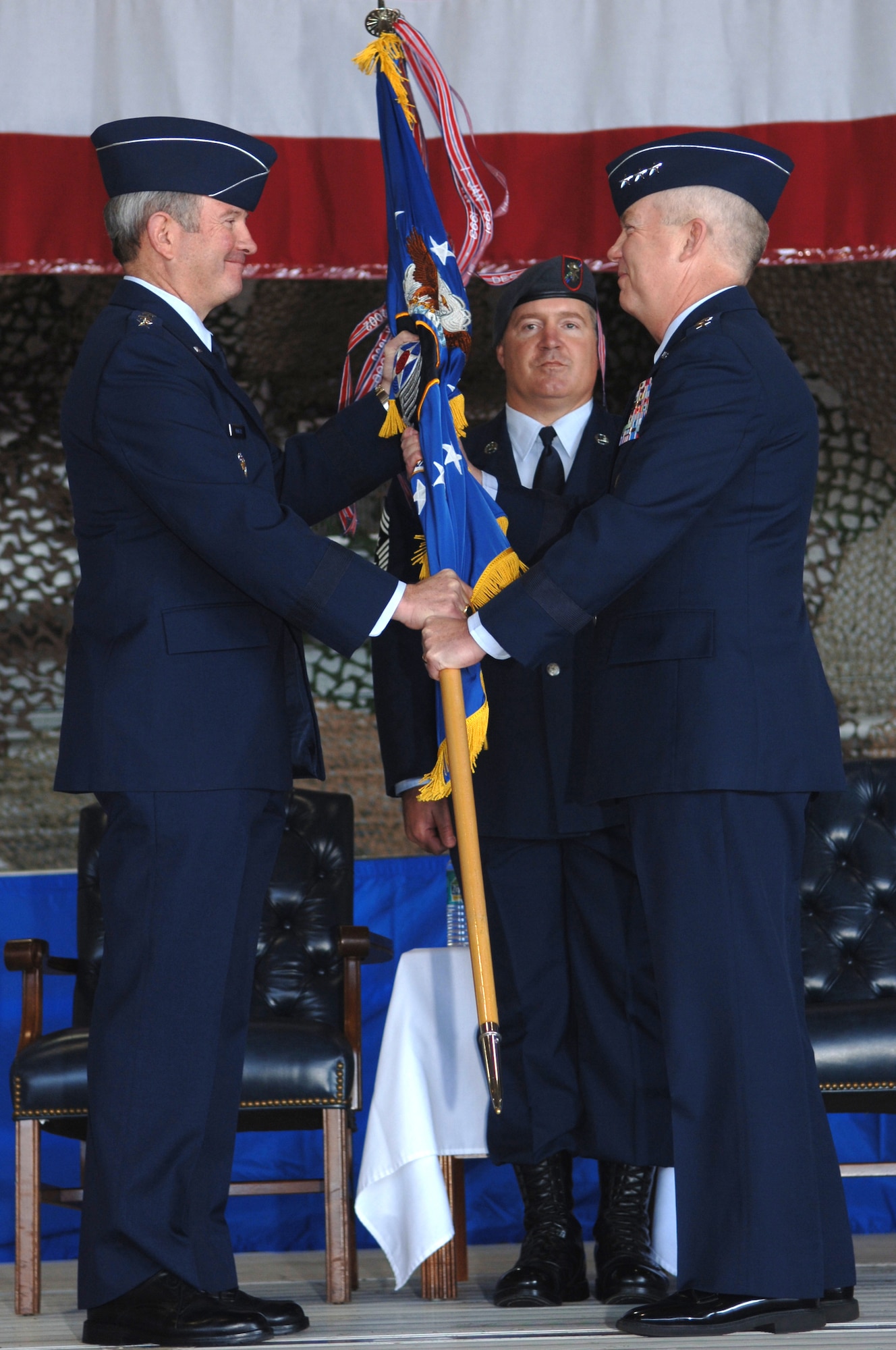 Lt. Gen. Donny Wurster (right) accepts command of Air Force Special Operations Command from Gen. Duncan McNabb (left), Air Force vice chief of staff, as Chief Master Sgt. Michael Gilbert (center), AFSOC command chief, looks on during the AFSOC change of command ceremony Nov. 27 at Hurlburt Field, Fla. General Wurster, who's previous assignment was AFSOC vice commander, also made history that day becoming the first Air Force helicopter pilot promoted to lieutenant general. (U.S. Air Force photo/Senior Airman Ali Flisek)