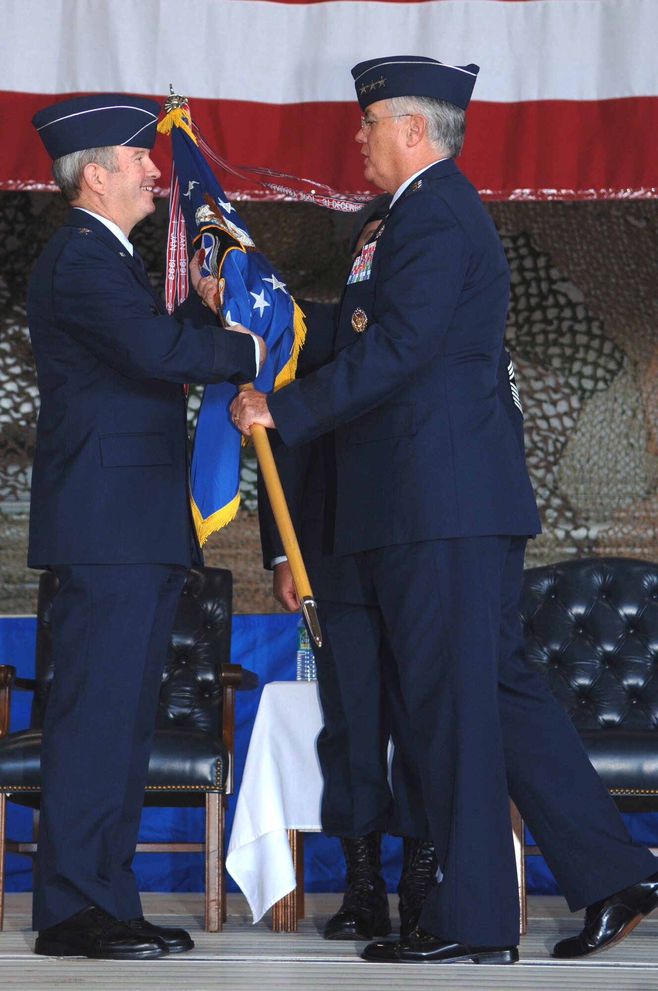 Lt. Gen. Mike Wooley (right), former Air Force Special Operations Command commander, passes the AFSOC guidon to Gen. Duncan McNabb (left) Air Force vice chief of staff, during the AFSOC change of command ceremony Nov. 27 at Hurlburt Field, Fla. By passing the guidon to General McNabb, General Wooley relinquished command of AFSOC to Lt. Gen. Donny Wurster. (U.S. Air Force Photo/Senior Airman Ali Flisek)