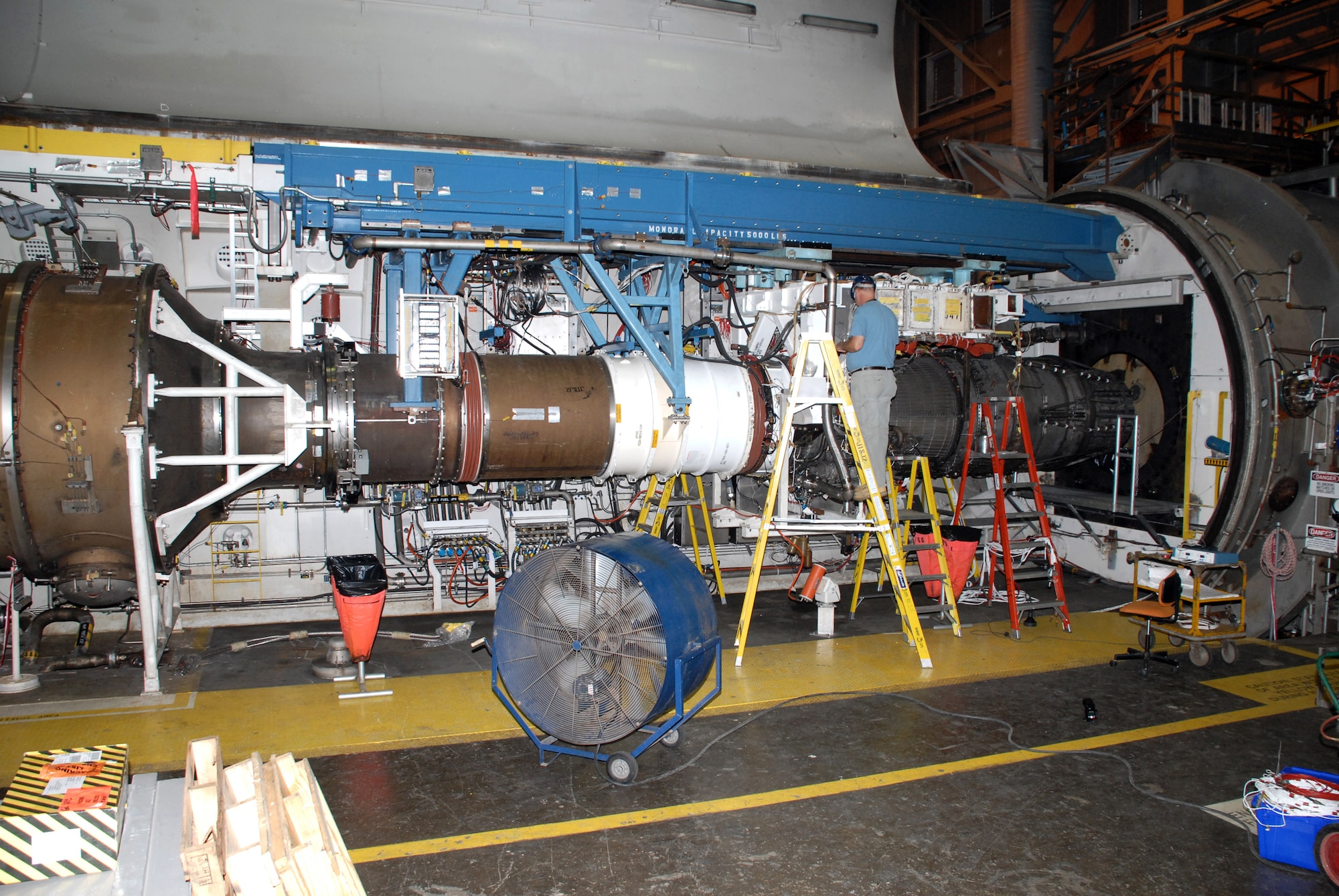 A test technician prepares the General Electric F101 engine for testing at Arnold Engineering Development Center at Arnold Air Force Base, Tenn. The F101 engine is slated to be the first high-performance, supersonic engine to be certified to run on a 50-50 blend of Fisher-Tropsch synthetic fuel and JP-8 fuel. (U.S. Air Force photo) 
