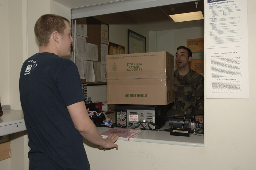 Airman 1st Class Carl Niger, 39th Communications Squadron infrastructure technician mails a package before the holiday deadlines with the assistance of Senior Airman Carlos Dominquez, 39th CS Official Document Center directory clerk. It is important for members to mail their packages on time to ensure they will reach the recipients before the holidays. (U.S. Air Force photo by Senior Airman Tiffany Colburn).