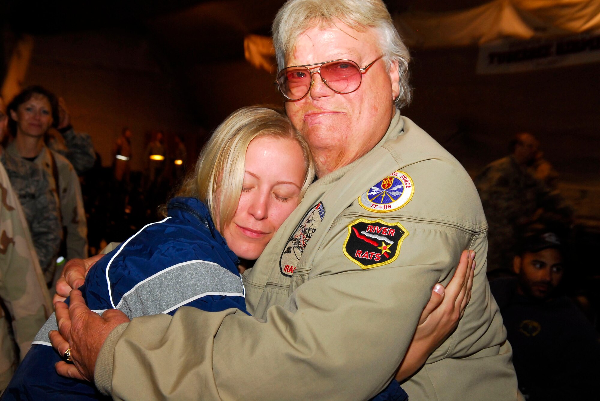 Senior Airman Amanda Arndt is comforted by Dave Roever after his Nov. 26 speech at Balad Air Base, Iraq. A severely disabled Vietnam War veteran, Mr. Roever delivered a message of hope and encouragement to servicemembers and extended the support of the American people. Airman Arndt, assigned to the 332nd Expeditionary Civil Engineer Squadron, is deployed from Yokota Air Base, Japan. (U.S. Air Force photo/Staff Sgt. Joshua Garcia) 
