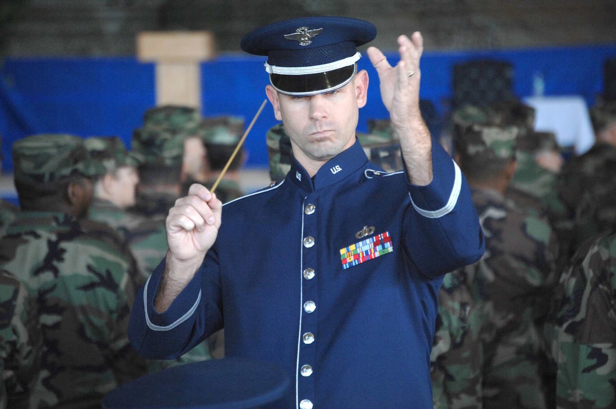Tech. Sgt. Aaron Miles, Band of the U.S. Air Force Reserve, leads the band in song prior to the Air Force Special Operations Command change of command ceremony Nov. 27 at Hurlburt Field, Fla. (U.S. Air Force photo/Senior Airman Stephanie Jacobs)