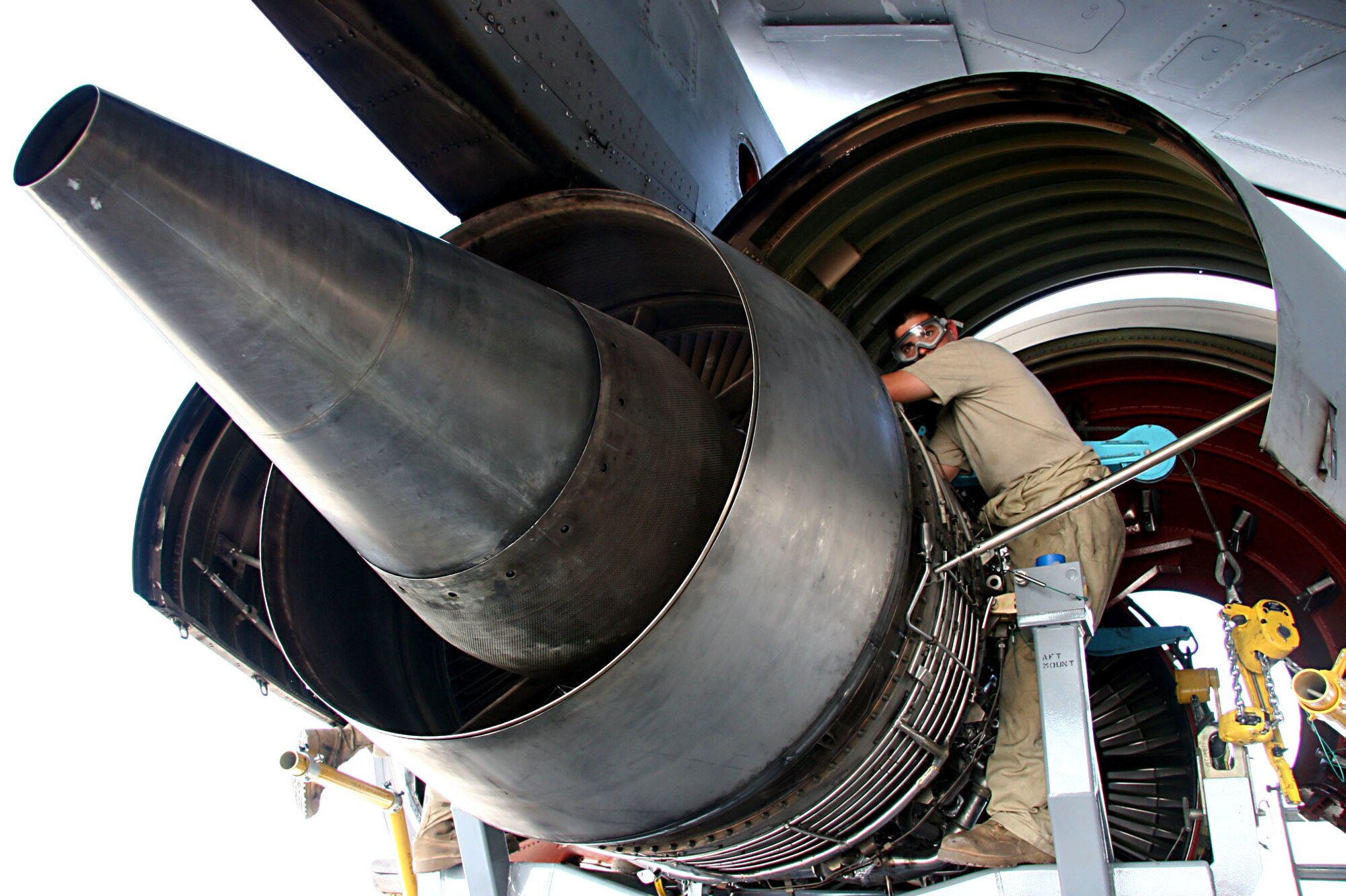 Airman 1st Class Louis Martens installs safety wires on the engine mounts of a KC-10 Extender engine Nov. 23 prior to installing the engine on the aircraft.  Airman Martens is with the 380th Expeditionary Aircraft Maintenance Squadron at an air base in Southwest Asia.  (U.S. Air Force photo/Master Sgt. Ruby Zarzyczny)