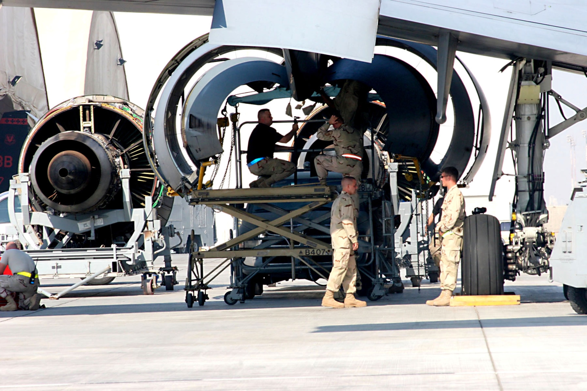 Maintainers from the 380th Expeditionary Aircraft Maintenance Squadron at an air base in Southwest Asia inspect the engine nacelle cowling of a KC-10 Extender Nov. 23 after removing a damaged engine.  (U.S. Air Force photo/Master Sgt. Ruby Zarzyczny)