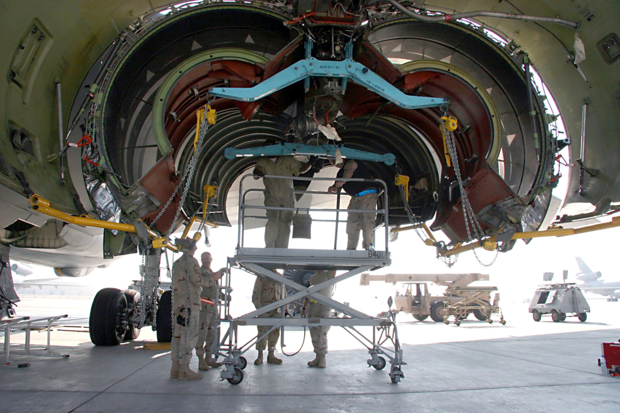 Maintainers from the 380th Expeditionary Aircraft Maintenance Squadron at an air base in Southwest Asia inspect the engine nacelle cowling of a KC-10 Extender Nov. 23 after removing a damaged engine.  (U.S. Air Force photo/Master Sgt. Ruby Zarzyczny)

