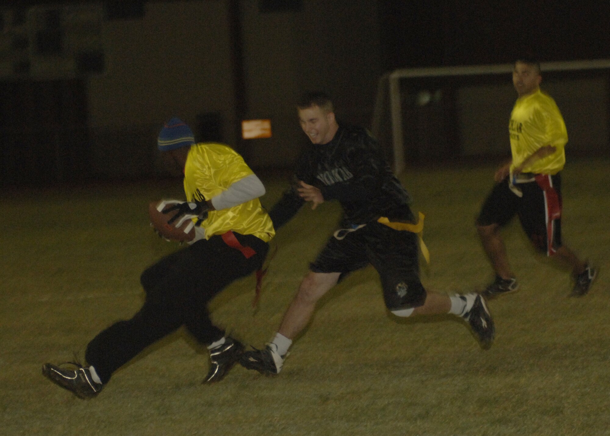 Senior Airman Byron Brown, 39th Services Squadron, grabs a flag from 1st Lt. Tavis Hundley, 728th Air Mobility Squadron, to prevent a touchdown during the Thanksgiving Flag Football game Nov. 23. The members of each team were the top five players from the intramural season. The final score of the game was Indians – 49 and Pilgrims – 13. (U.S. Air Force photo by Senior Airman Tiffany Colburn)