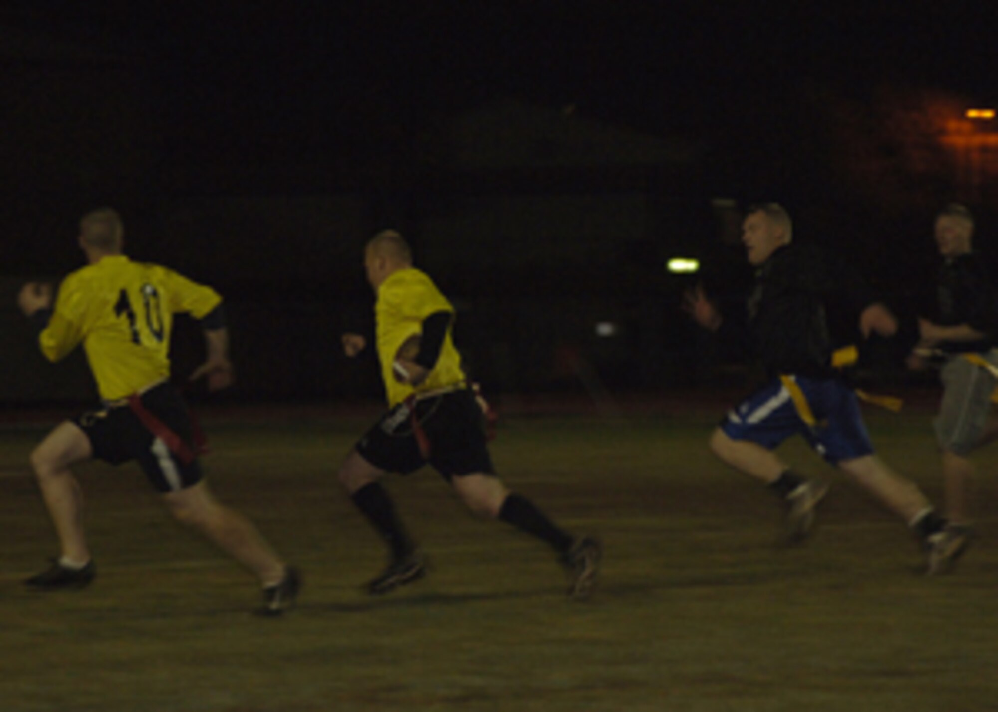 Members of the Pilgrim team rush to the goal line for a touchdown during the Thanksgiving Flag Football game Nov. 23. Even though there were no prizes, bragging rights were more than enough for the two competing teams. (U.S. Air Force photo by Senior Airman Tiffany Colburn)