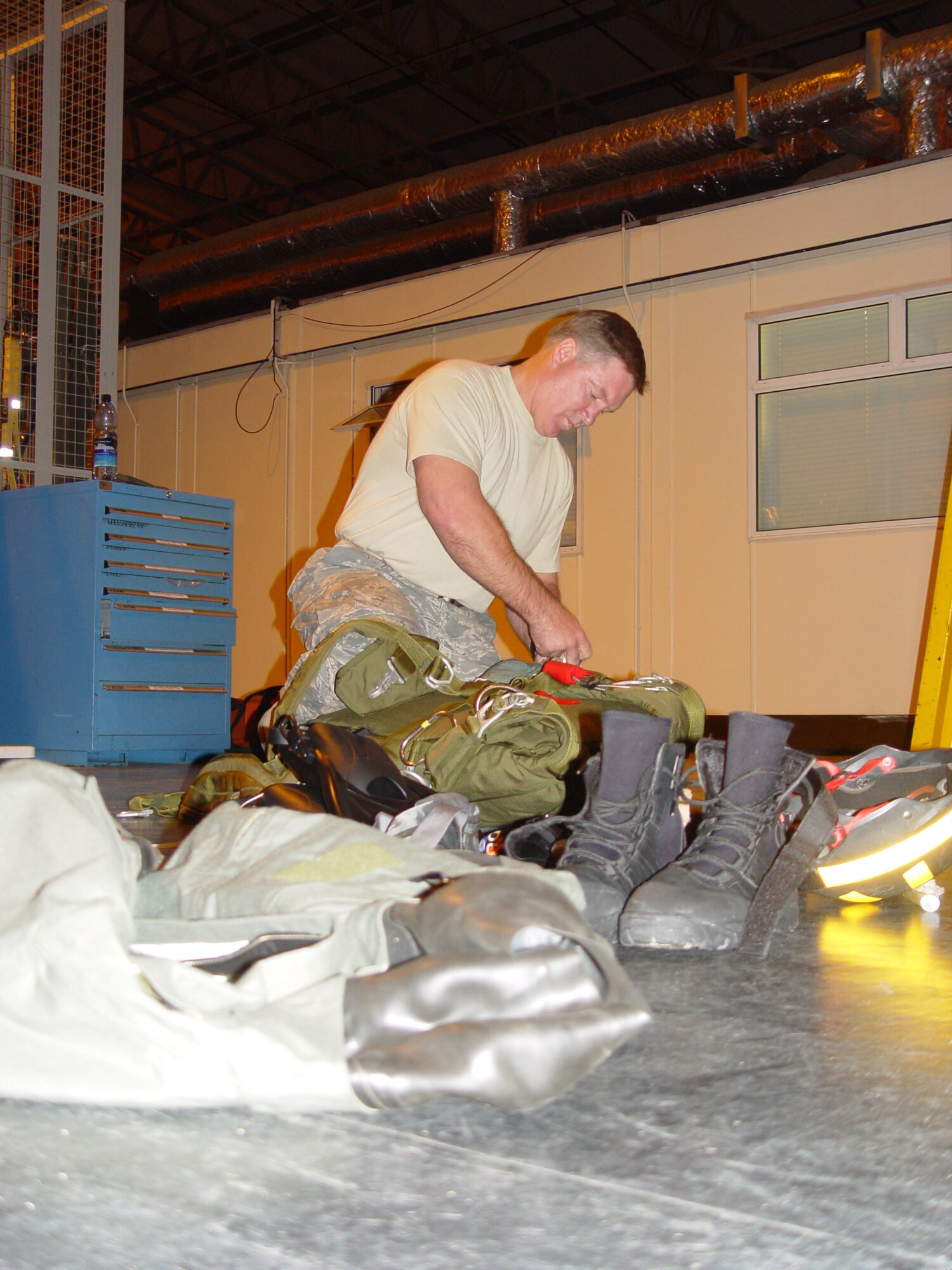 Chief Master Sgt. Michael Gilbert, Air Force Special Operations Command's command chief master sergeant, checks his jump gear prior to “jockin up” for a night time water training event in the North Sea with the 321st Special Tactics Squadron operators. (U.S. Air Force photo by Master Sgt. Dennis Brewer)