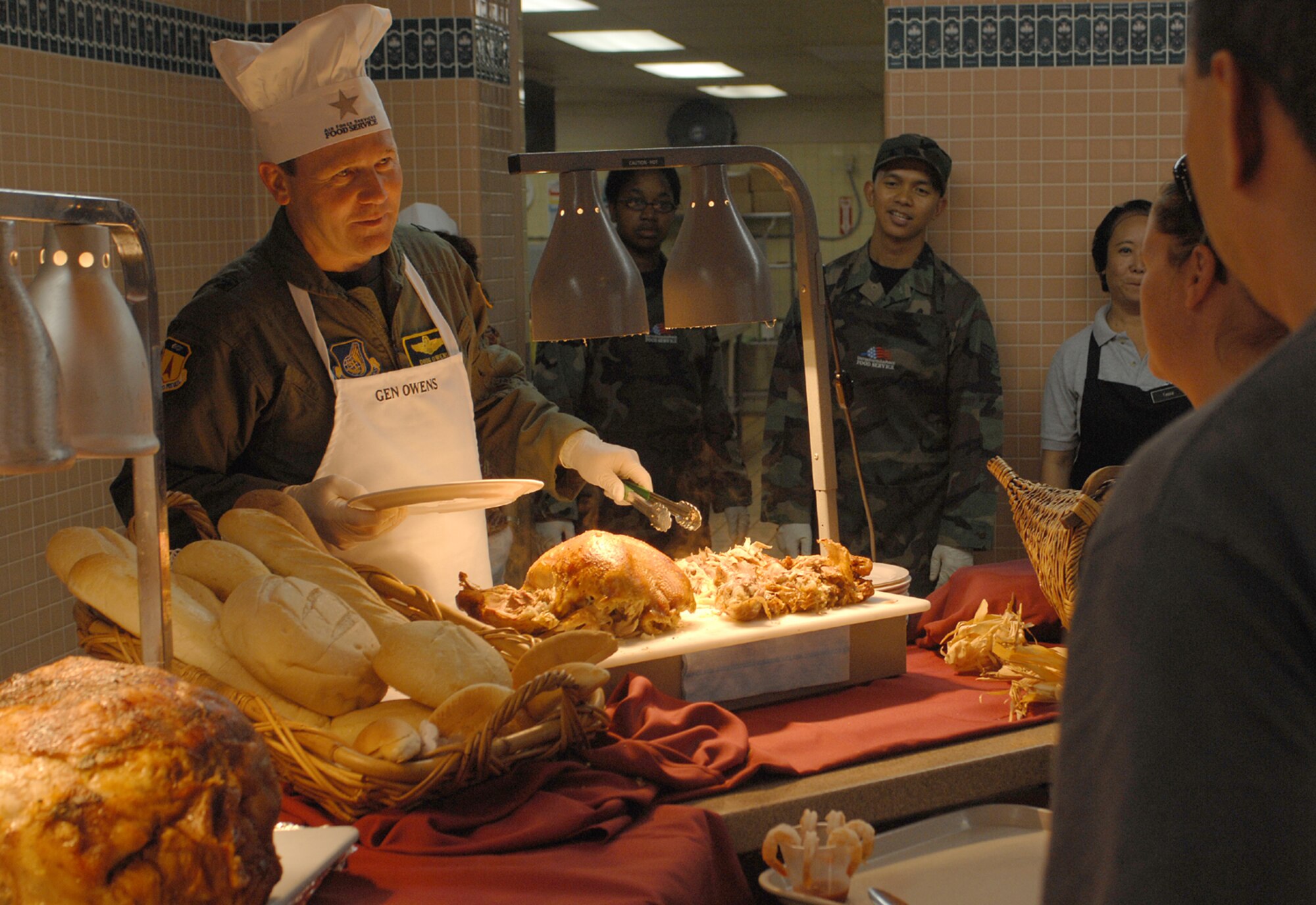 On Thanksgiving Day, Brig. Gen. Doug Owens, 36th Wing commander, and other senior leaders served hot meals to Andersen military members at the Magellan Inn Dining Facility. (U.S. Air Force photo/Senior Airman Angelique Smythe) 


