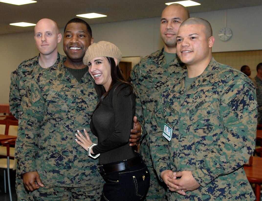 Model Mayra Veronica poses for a photo with Marines at Landstuhl Regional Medical Center, Germany, Nov. 24, 2007. Veronica visited the hospital with Vice Chairman of the Joint Chiefs of Staff Marine Corps Gen. James E. Cartwright. 