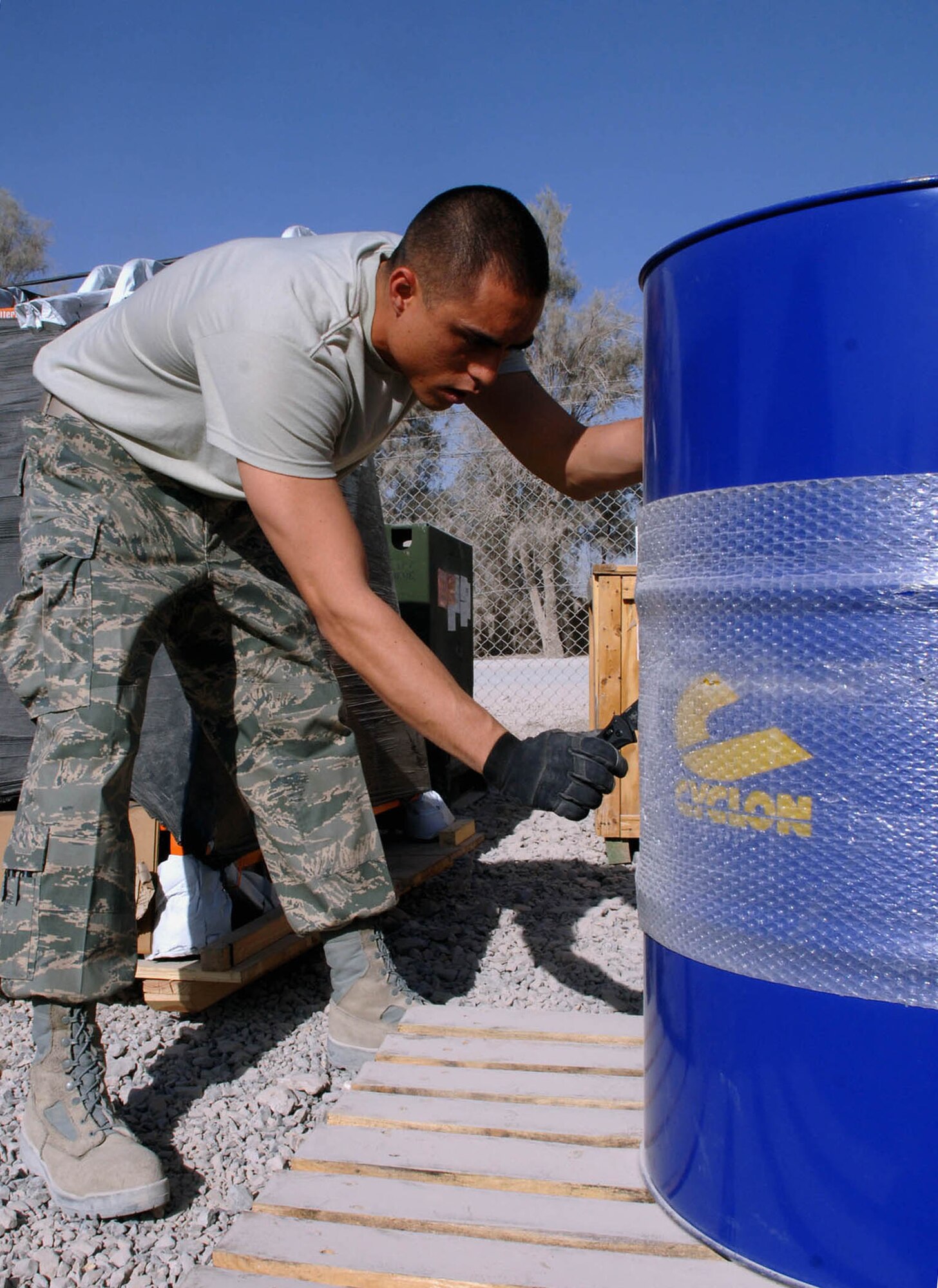 KANDAHAR, Afghanistan -- Staff Sgt. Sean Garcia, the Base Service Center supervisor for the 451st Air Expeditionary Group Logistics Readiness Flight here, prepares a supply container for distribution. The flight services more than 500 Airmen deployed here by processing anywhere from 100,000 to several million dollars worth of equipment and supply assets each day. (U.S. Air Force Photo by Staff Sgt. Mike Andriacco)
