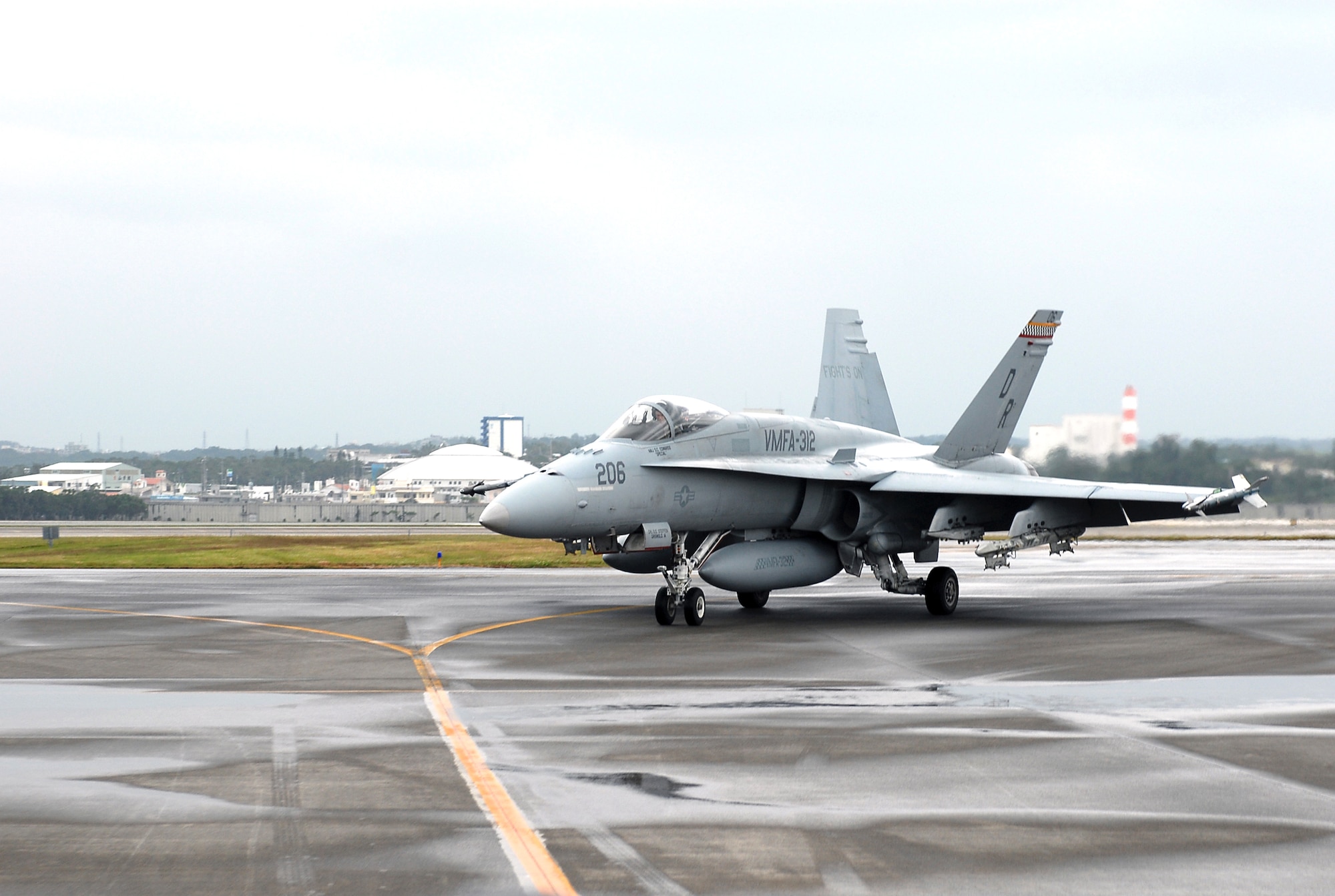 An F-18 Hornet from the Marine Group 12, based at Marine Corps Air Station Iwakuni, Japan, taxis down Kadena Air Base's flightline, Nov. 28, to participate in the 18th Wing's upcoming local operation readiness exercise.  The exercise will give Kadena the opportunity to test their unit reception monitors' ability to process the incoming 600 MAG-12 Marines and 500 tons of MAG-12 cargo by air and sea. This will aid the 18th Wing as they prepare for the Pacific Air Forces Operational Readiness Inspection in March.  (U.S. Air Force photo/Airman First Class Kelly Timney)