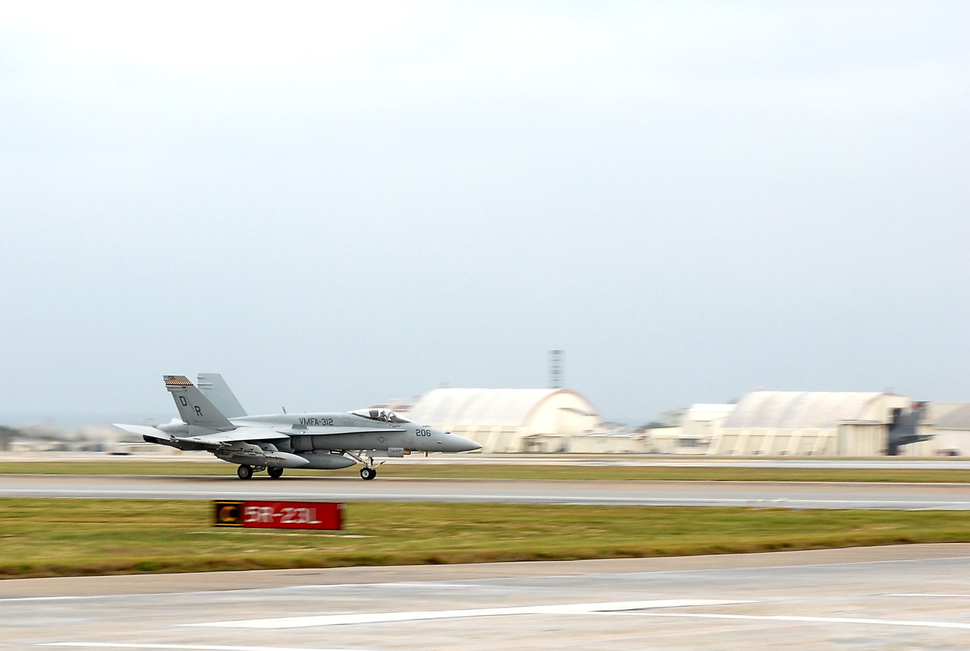 An F-18 Hornet from the Marine Group 12, based at Marine Corps Air Station Iwakuni, Japan, lands at Kadena Air Base, Japan, Nov. 28, to participate in the Air Force's upcoming local operation readiness exercise.  The MAG-12 Marines deployed their group to focus on unit-level training and by doing so, gave the Air Force the opportunity to exercise their reception of forces plan on a large scale.  (U.S. Air Force photo/Airman First Class Kelly Timney)