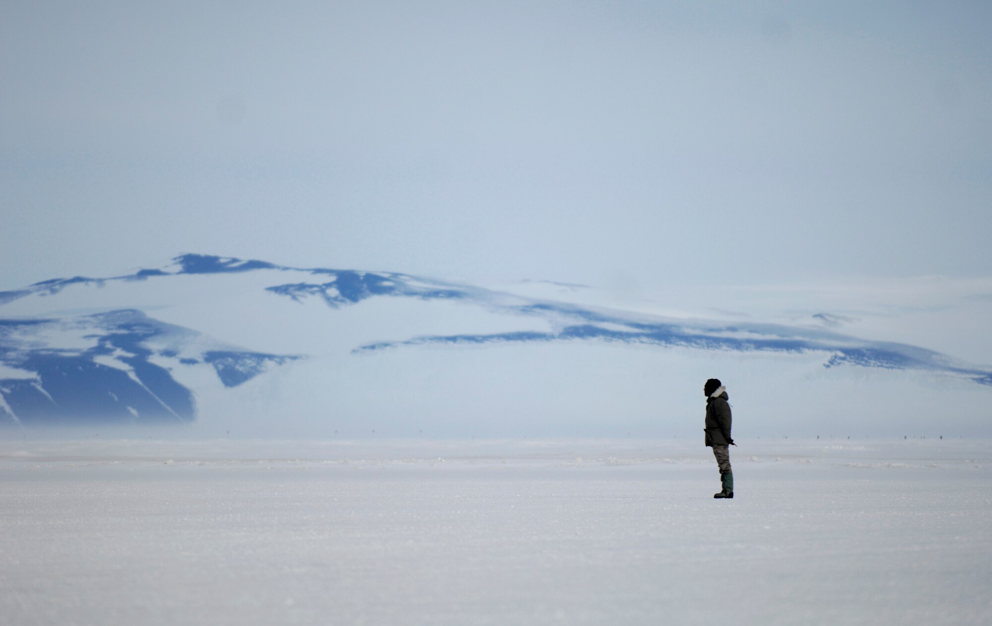 Tech. Sgt. Kevin Call waits to marshal an LC-130 Hercules from its parking spot on the annual sea ice runway near McMurdo Station, Antarctica Nov. 26, 2007 during Operation Deep Freeze. Sgt. Call is a crew chief with the New York Air National Guard’s 109th Airlift Wing. Ski-equipped LC-130s, crews and support personnel are supporting the 13th Air Force-led Joint Task Force Support Forces Antarctica, Operation Deep Freeze. Operation Deep Freeze is a unique joint and total force mission that has supported the National Science Foundation and U.S. Antarctic Program that began in 1955. (U.S. Air Force photo/Tech. Sgt. Shane A. Cuomo)