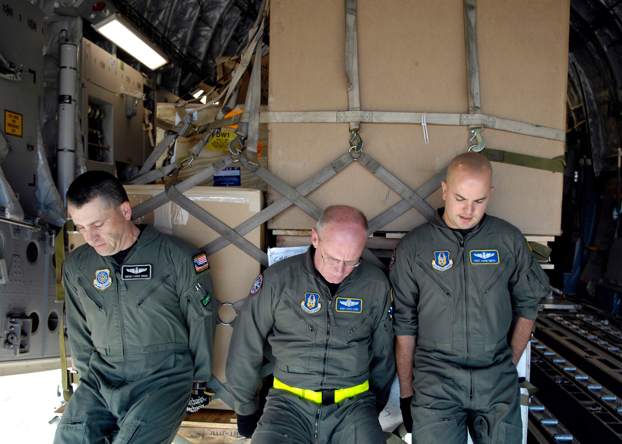 Senior Master Sgt. Louis Orrie, Master Sgt. Lyle Lane and Staff Sgt. Gavin Smith push a pallet onto their C-17 Globemaster III prior to taking off from Christchurch, New Zealand Nov. 26, 2007 during Operation Deep Freeze. The Airmen, loadmaster, along with other Reserve and active duty Airmen from McChord Air Force Base, Wash. are at Christchurch supporting the 13th Air Force-led Joint Task Force Support Forces Antarctica, Operation Deep Freeze. Operation Deep Freeze is a unique joint and total force mission that has supported the National Science Foundation and U.S. Antarctic Program that began in 1955. (U.S. Air Force photo/Tech. Sgt. Shane A. Cuomo)
