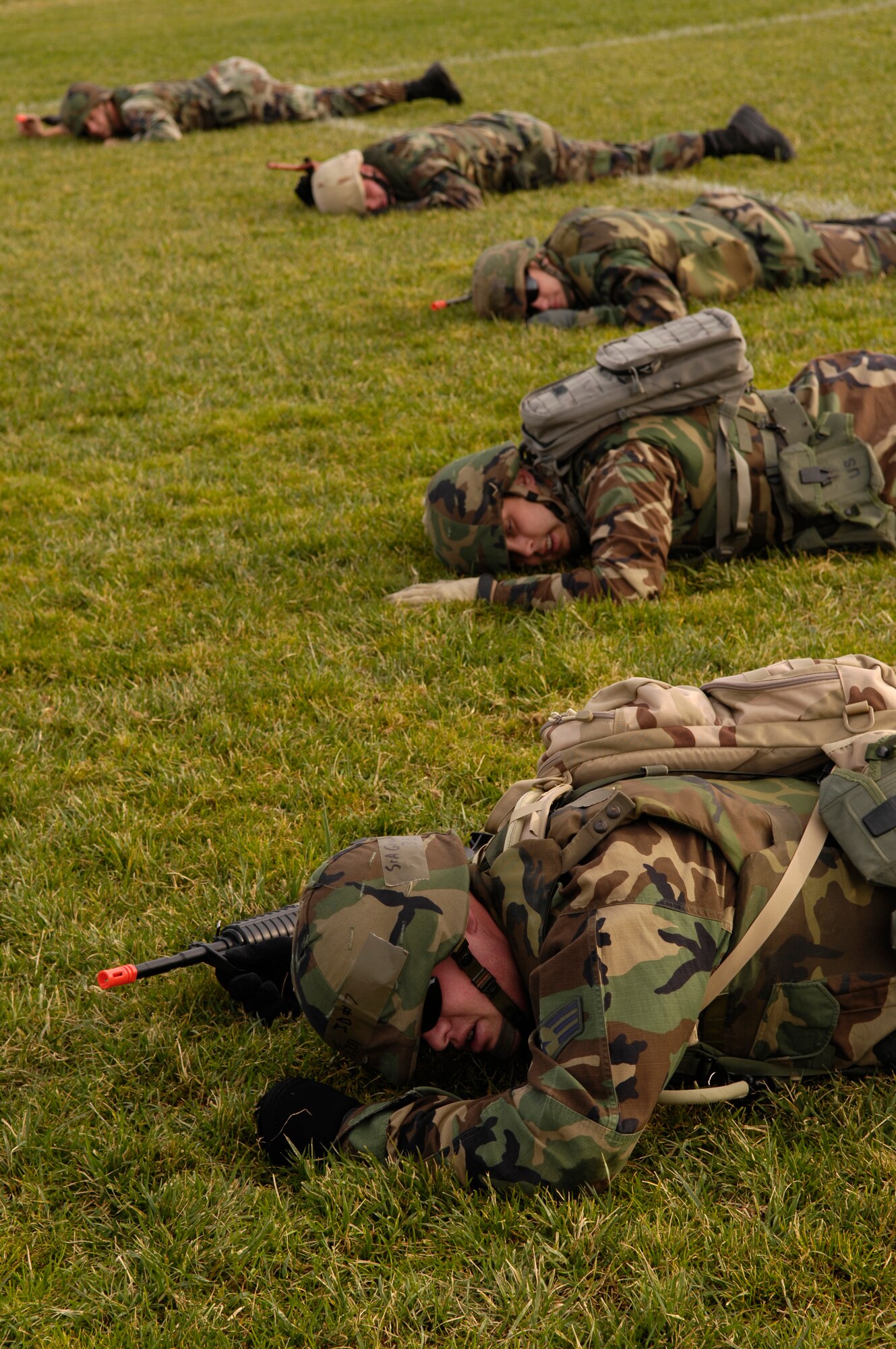 VANDENBERG AIR FORCE BASE, Calif. -- Airmen participating in Combat Airmen Training low crawl for 75 yards in Cocheo Park on Nov. 28. Combat Airmen Training was created to help Airmen become more effective warriors during the Air Force's transition toward both an air and ground force. Airmen support other military branches on ground assaults against terrorists the world over, which makes additional training an invaluable asset. (U.S. Air Force photo/Airman 1st Class Christian Thomas)