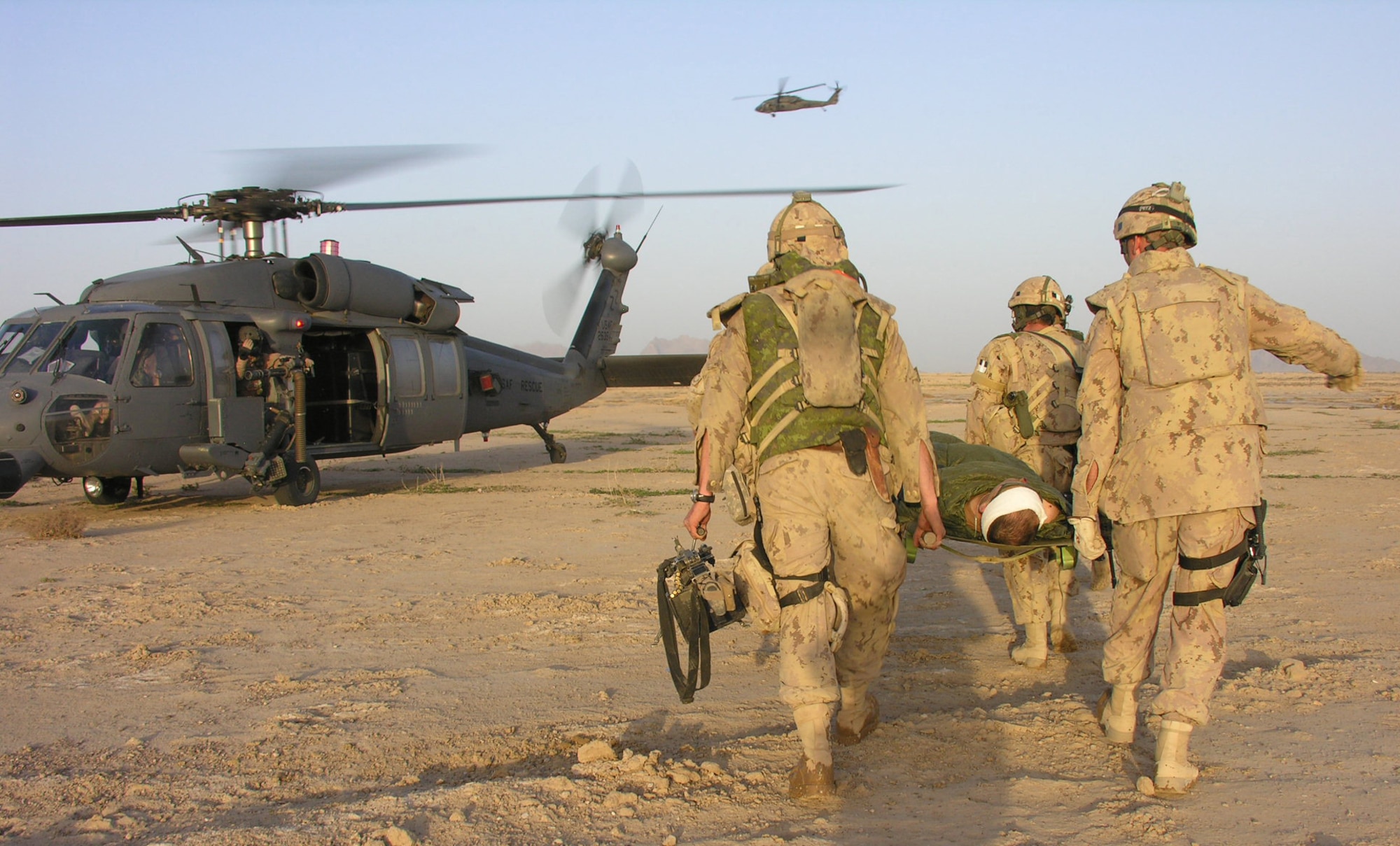 Coalition soldiers move another injured coalition soldier to a Kadena-based 33rd Expeditionary Rescue Squadron HH-60 Pave Hawk helicopter at a forward operating base in Afghanistan. The 33rd ERSQ continues combat flight operations in Afghanistan during their five-month deployment to Operation Enduring Freedom. So far the squadron has saved 102 people while flying more than 330 combat hours. The squadron is flying an in lieu medical evacuation missions with the U.S. Army and other coalition forces. The 33rd ERQS is comprised of personnel from throughout the 18th Wing, including the 718th Aircraft Maintenance Squadron, 67th Fighter Squadron and 18th Munitions Squadron. (U.S. Air Force/courtesy 33rd ERQS)