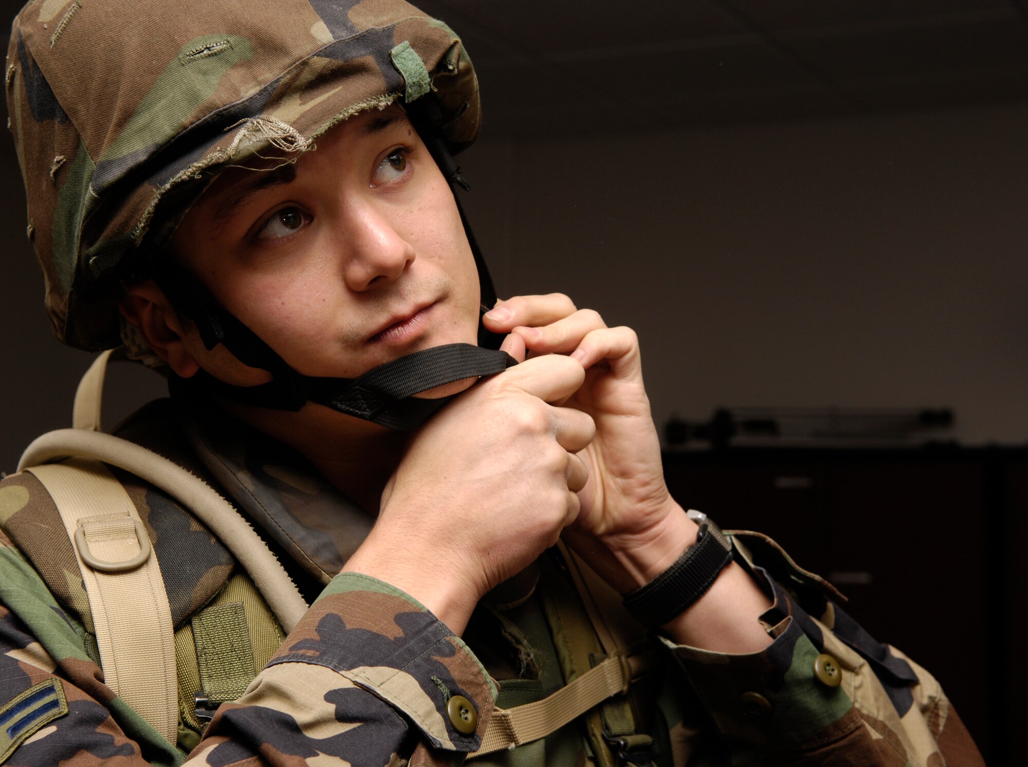 VANDENBERG AIR FORCE BASE, Calif. -- Airman 1st Class Jonathan Foster dons a helmet to prepare for team tactical movements during Combat Airmen Training on Nov. 28.  The broadcaster is with the 30th Space Wing Public Affairs office. He and other Airmen participated in the training created to help Airmen become more effective warriors during the Air Force's transition toward both an air and ground force. Airmen support other military branches on ground assaults against terrorists the world over, which makes additional training an invaluable asset. (U.S. Air Force photo/Airman 1st Class Christian Thomas)