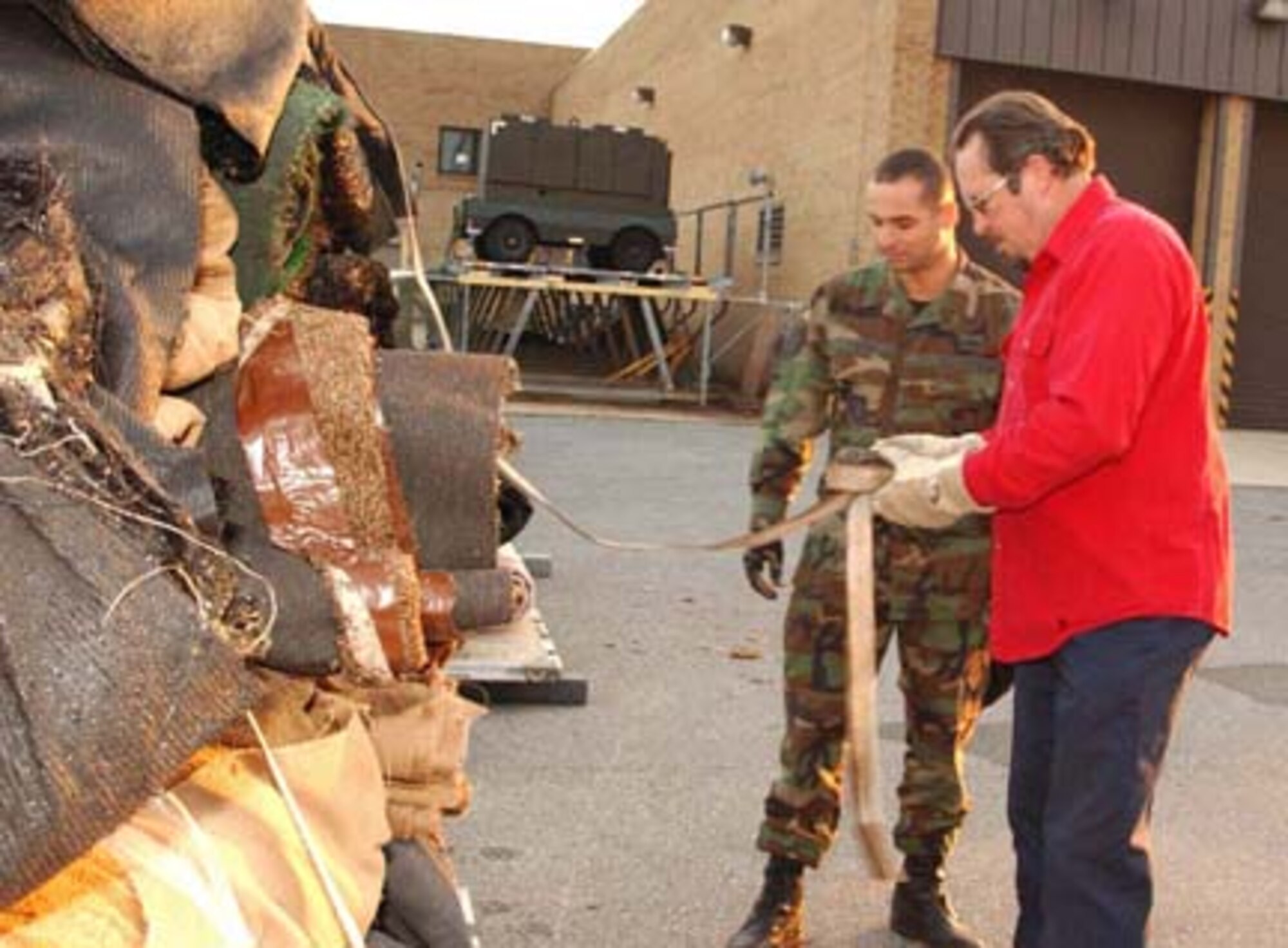 ANDREWS AIR FORCE BASE, Md. --Tech. Sgt. Nicholas Karim, 459th Civil Engineer Squadron engineering craftsman, and Jim Snider, 69th Aerial Port Squadron transportation specialist, secure goods on a pallet here to airlift pallets bound for Southwest Asia Nov. 19. Wing members joined Jan Bradley to send shoes, clothes, rugs, toys and other goods downrange as part of Operation Care, a relief coalition designed to assess humanitarian needs and offer aid to promote self-sufficiency, prosperity and a healthy environment for displaced villagers. Mrs. Bradley is the spouse of Air Force Reserve Command Chief Lt. Gen. John A. Bradley. (U.S. Air Force photo/Staff Sgt. Amaani Lyle)