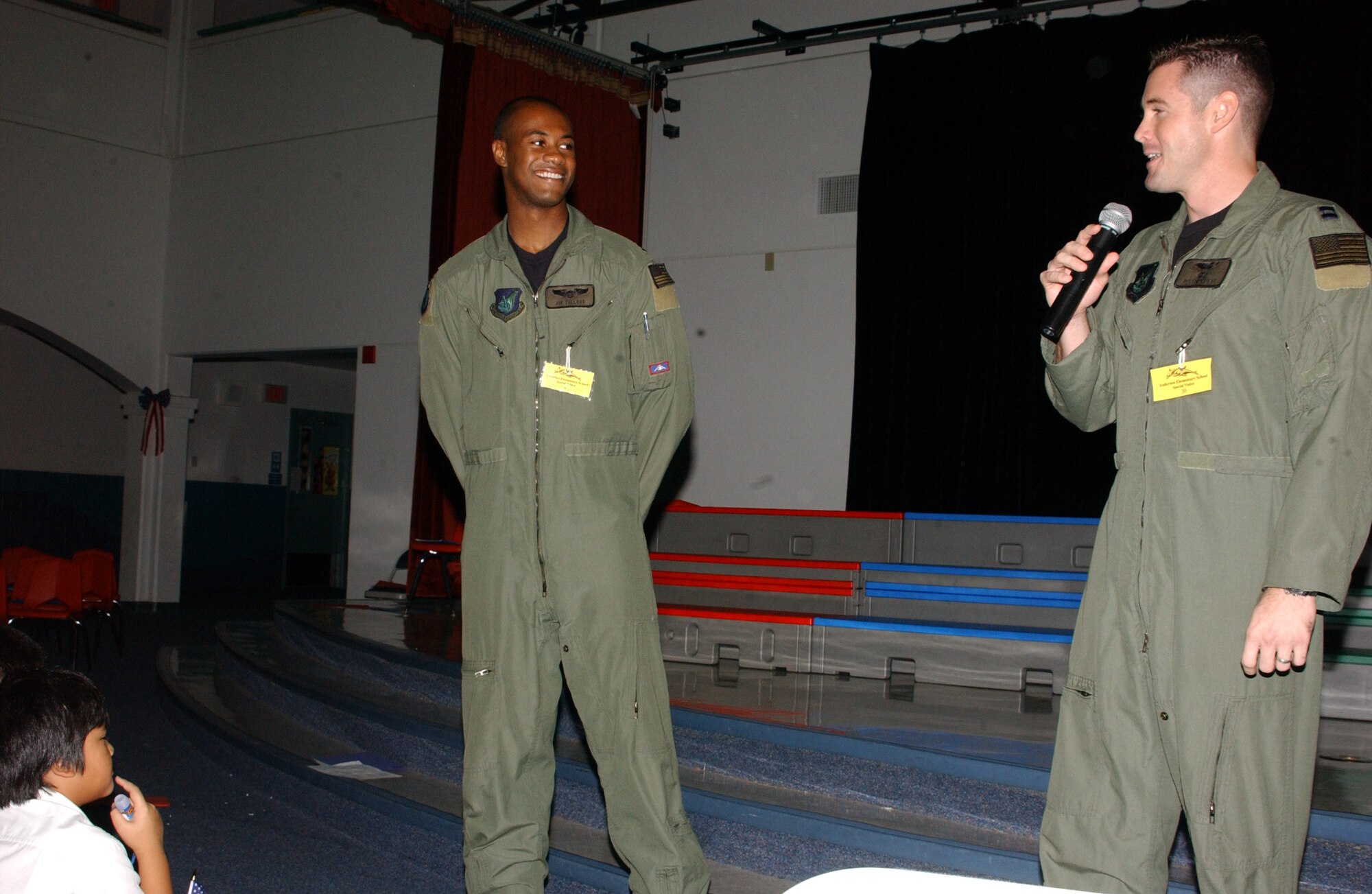 Capt. Joe Tullos, 393rd Expeditionary Bomb Squadron standardization and evaluation officer (left) and Capt. Justin Grieves, 393rd EBS weapons and tactics officer, discuss the B-2 bomber’s unique capability and share their Air Force experiences at Andersen’s middle school prior to the static aircraft display event. Both of the stealth bomber aviators were available for photos with the students and spent time with what could be the Air Force’s future in the years to come. (Air Force photo/Tech. Sgt. Steven Wilson)