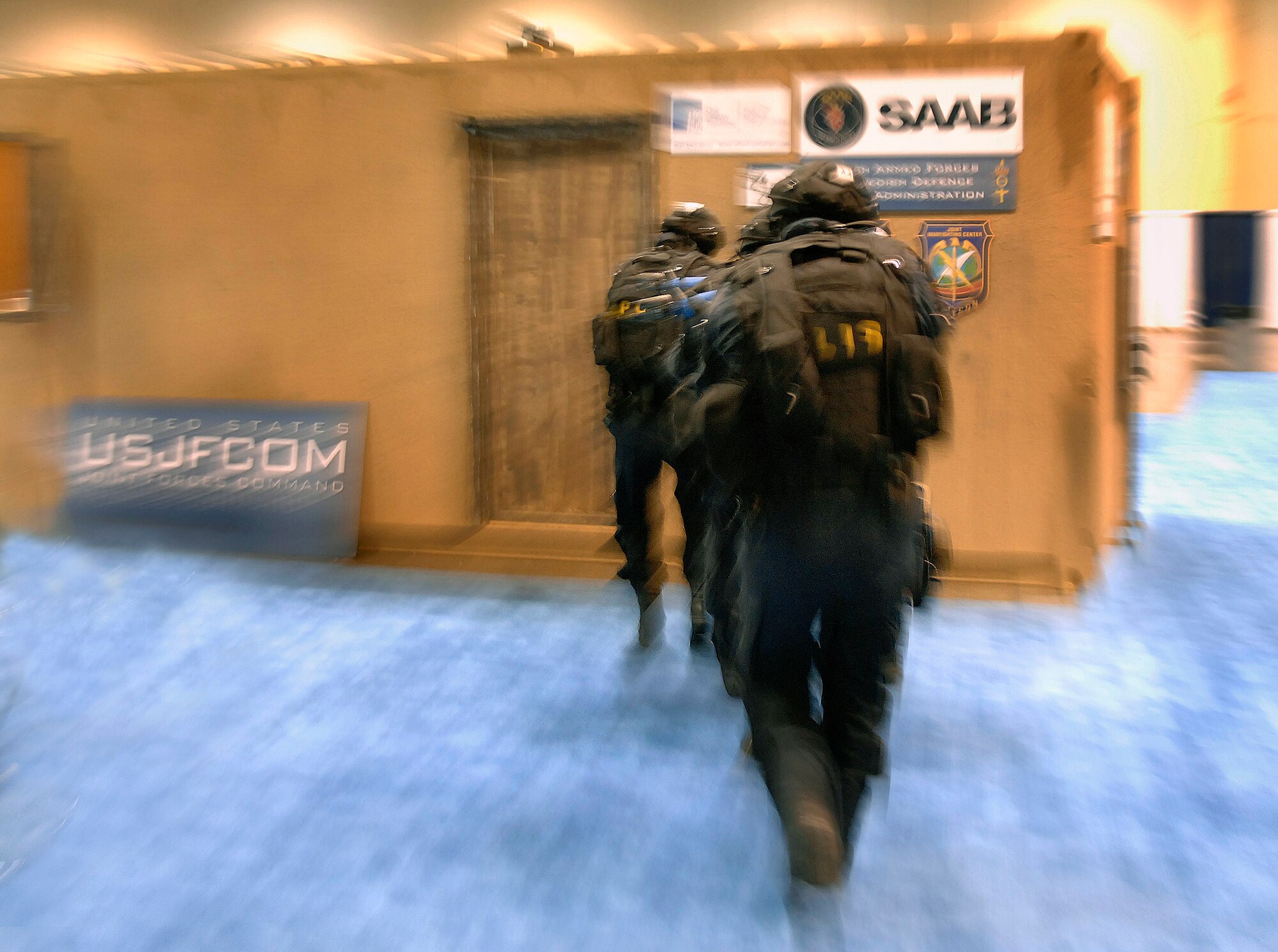 A Swedish special weapons and tactics team rushes into a simulated hostage rescue situation Nov. 27 during the Interservice/Industry Training, Simulation and Education Conference in Orlando, Fla. (U.S. Air Force photo/Tech. Sgt. Larry A. Simmons)
