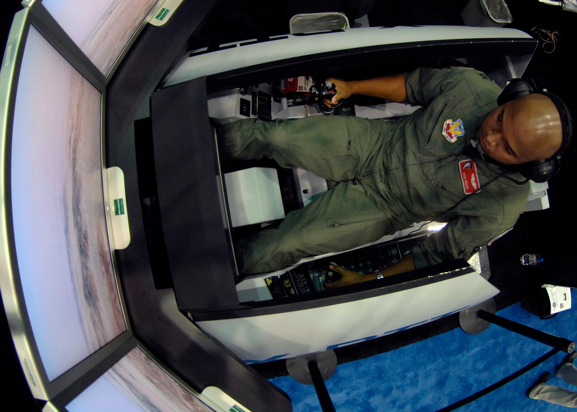 Capt. Rich Peace navigates a mission in the X-DTT Experimental Deployable Tactical Trainer while receiving instructions from a joint terminal attack controller Nov. 28 during the Interservice/Industry Training, Simulation and Education Conference in Orlando, Fla. Captain Peace is an F-16 Fighting Falcon pilot with the 100th Fighter Squadron from Alabama. (U.S. Air Force photo/Tech. Sgt. Larry A. Simmons) 
