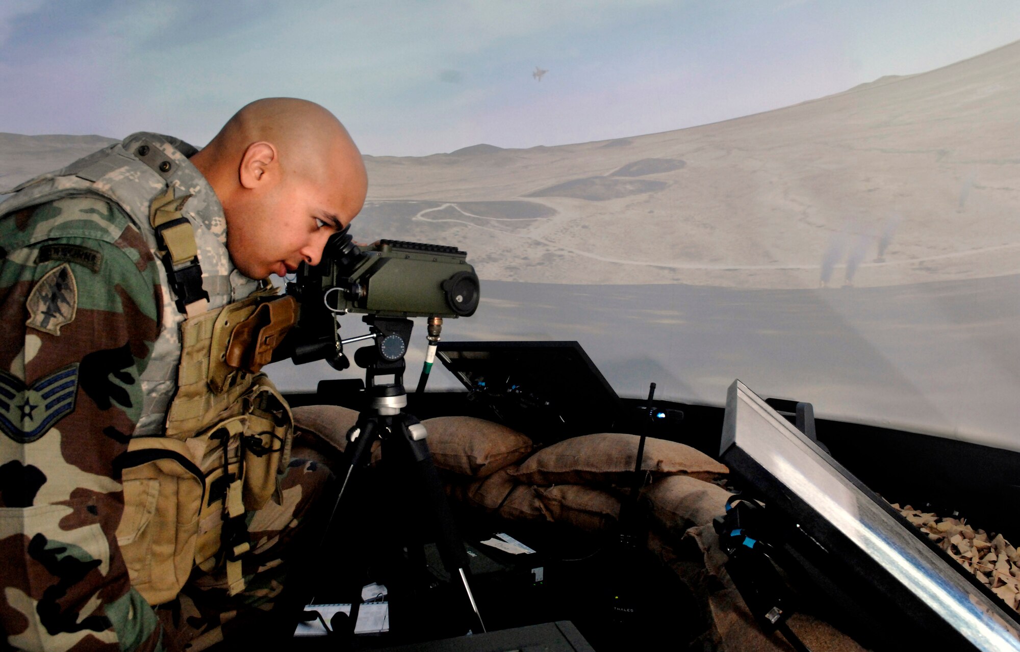 Staff Sgt. Dennis Krouse surveys the are before he calls in close-air support Nov. 28 during a simulation at the Interservice/Industry Training, Simulation and Education Conference in Orlando, Fla. Sergeant Krouse is a joint terminal attack controller stationed at Fort Hood, Texas. (U.S. Air Force photo/Tech. Sgt. Larry A. Simmons) 
