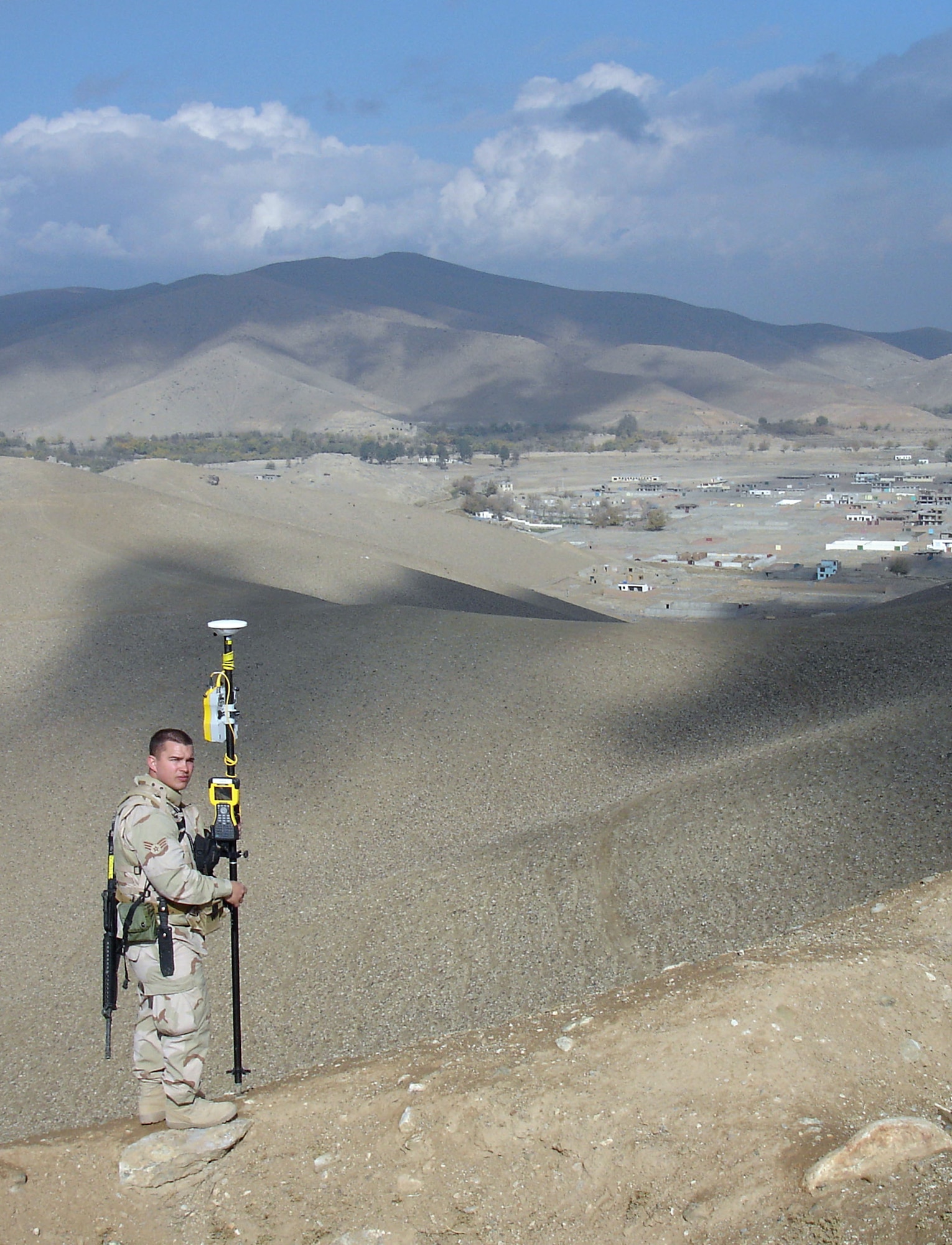 SrA Mark Peterson, 755th EMSG/ECES, uses a GPS rover to collect data points while surveying the 840-acre site of a new training compound for the Afghan National Army. (U.S. Air Force photo)