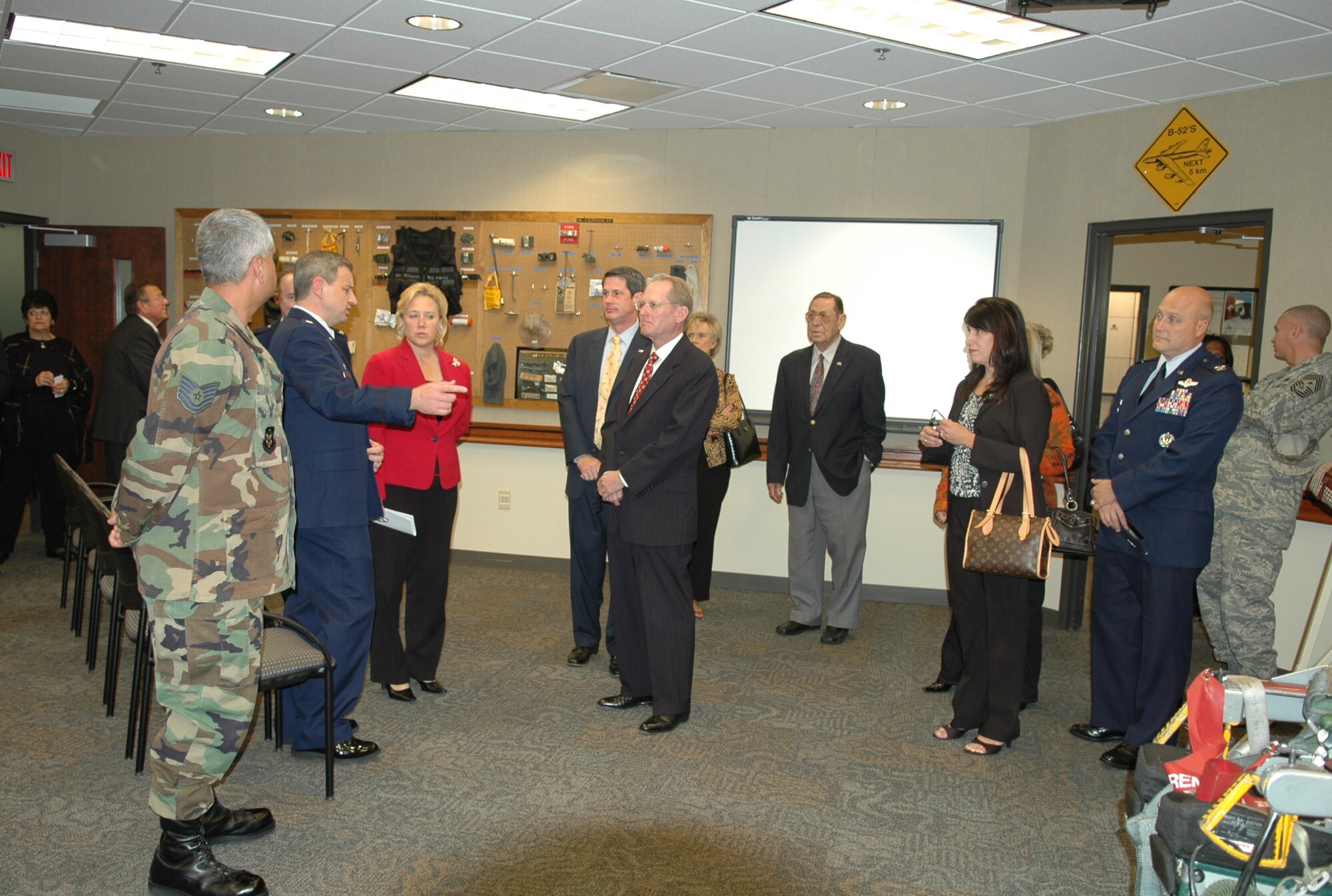Lt. Col. Al Teauseau (pointing), 93d Bomb Squadron commander, leads a tour of the new 93 BS operations facility Wednesday, Nov. 28, following a ceremony celebrating the buildling opening. (U.S. Air Fore photo/Master Sgt. Sherri Bohannon)