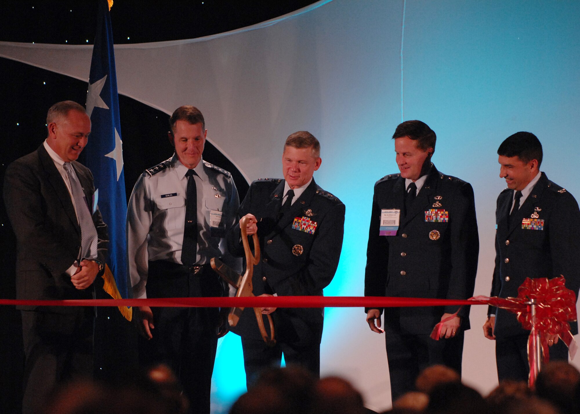 (L-R)Craig Spohn, Cyber Innovation Center director, Lt. Gen. Ted Bowlds, Electronic Systems Center commander, Maj. Gen. William Lord, Air Force Cyber Command (provisional) commander, and Col. Paul Suarez, Air Force Network Operations commander, look on as Lt. Gen. Robert Elder, Headquarters Eighth Air Force commander cuts the ribbon at the "Fly and Fight in Cyberspace" Symposium Nov. 28 in Shreveport, La.  More than 1,700 people attended the three-day event. (U.S. Air Force photo/Airman First Class Joanna M. Kresge)