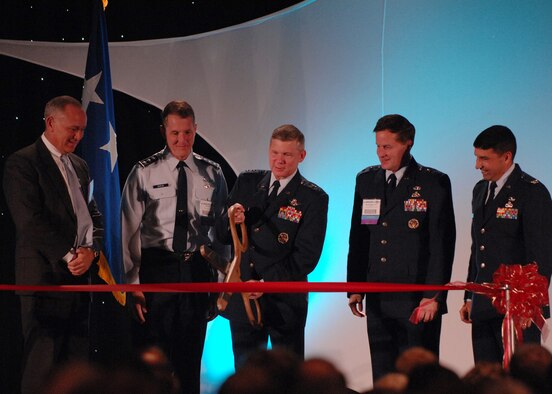 (L-R)Craig Spohn, Cyber Innovation Center director, Lt. Gen. Ted Bowlds, Electronic Systems Center commander, Maj. Gen. William Lord, Air Force Cyber Command (provisional) commander, and Col. Paul Suarez, Air Force Network Operations commander, look on as Lt. Gen. Robert Elder, Headquarters Eighth Air Force commander cuts the ribbon at the "Fly and Fight in Cyberspace" Symposium Nov. 28 in Shreveport, La.  More than 1,700 people attended the three-day event. (U.S. Air Force photo/Airman First Class Joanna M. Kresge)