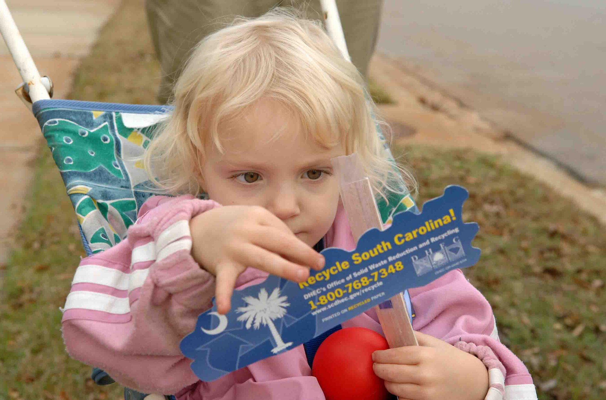 SHAW AIR FORCE BASE, S.C. -- Amelie, 2-year-old daughter of Staff Sgt. Nicole Helbing, 20th Forward Support Squadron fitness shift supervisor, looks at the contents of the Recycling Family of the Month Award gift package Nov. 27. (U.S. Air Force photo/Airman 1st Class Kathrine McDowell)