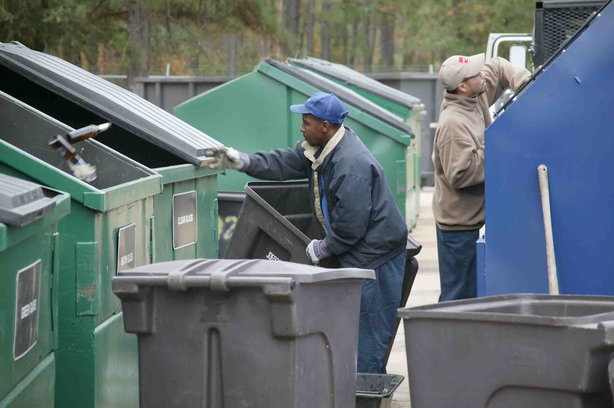 SHAW AIR FORCE BASE, S.C. -- Dana Green (right), Shaw's recycle center attendant, and Julious Nichols, recycling driver, sort and clean the many bins at the recycling center Nov. 27. Shaw recycles aluminum cans, plastic and glass bottles, office paper, newspaper, magazines, cardboard, printer cartridges, shoes and metals. (U.S. Air Force photo/Staff Sgt. John Gordinier)