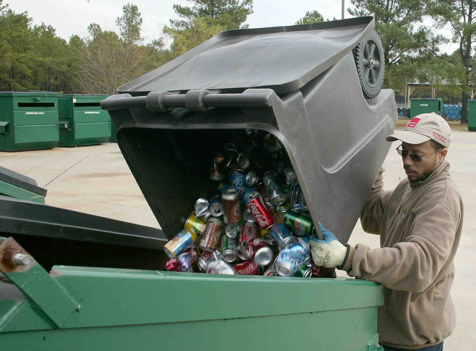 SHAW AIR FORCE BASE, S.C. -- Dana Green, Shaw's recycle center attendant, sorts and cleans the many bins at the recycling center Nov. 27. Shaw recycles aluminum cans, plastic and glass bottles, office paper, newspaper, magazines, cardboard, printer cartridges, shoes and metals. (U.S. Air Force photo/Staff Sgt. John Gordinier)